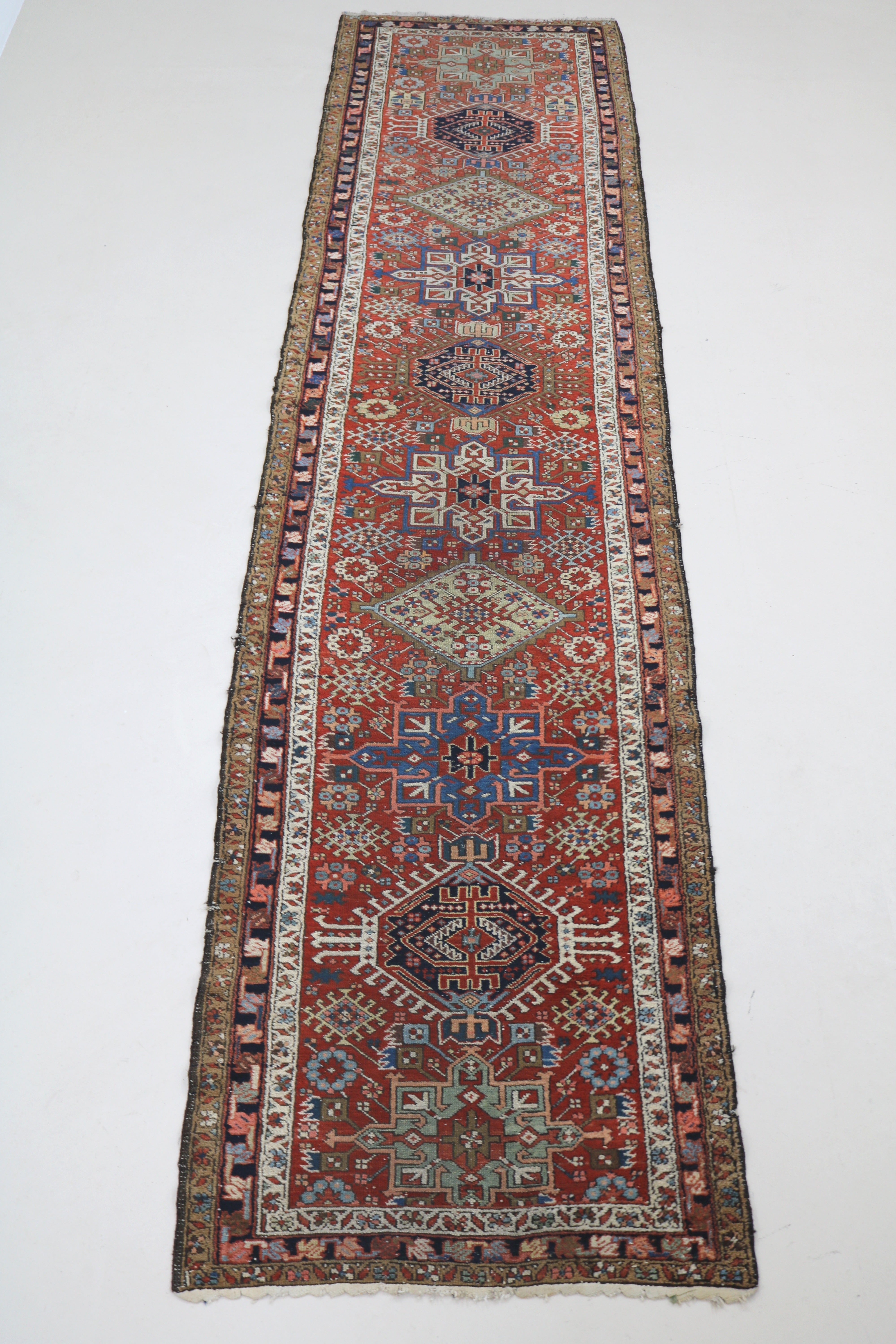 Full view of antique Persian Karaja runner with stepped medallion layout
