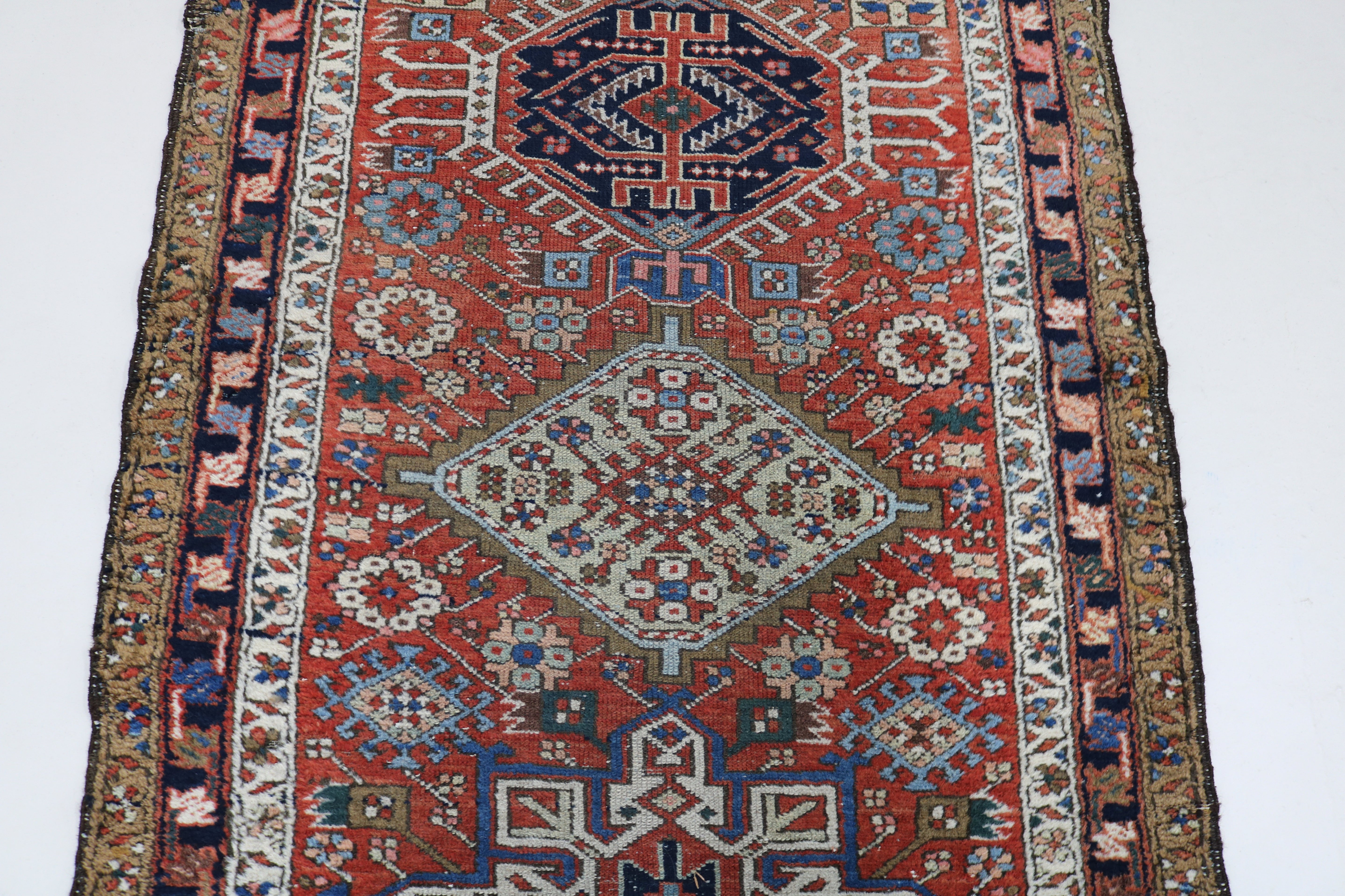 Close-up of geometric field motifs on antique Persian Karaja runner
