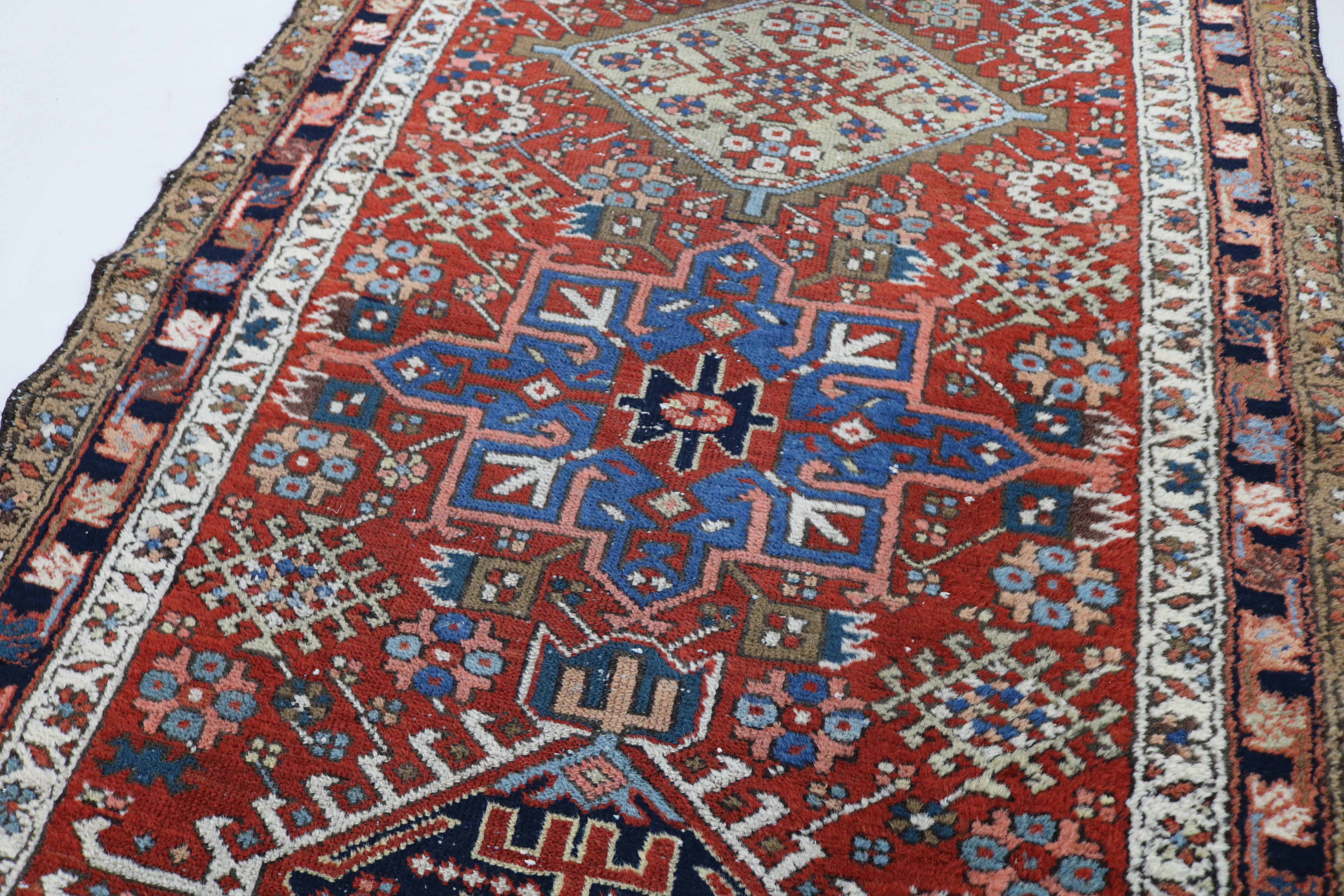 Close-up of hand-knotted wool texture on antique Persian Karaja runner
