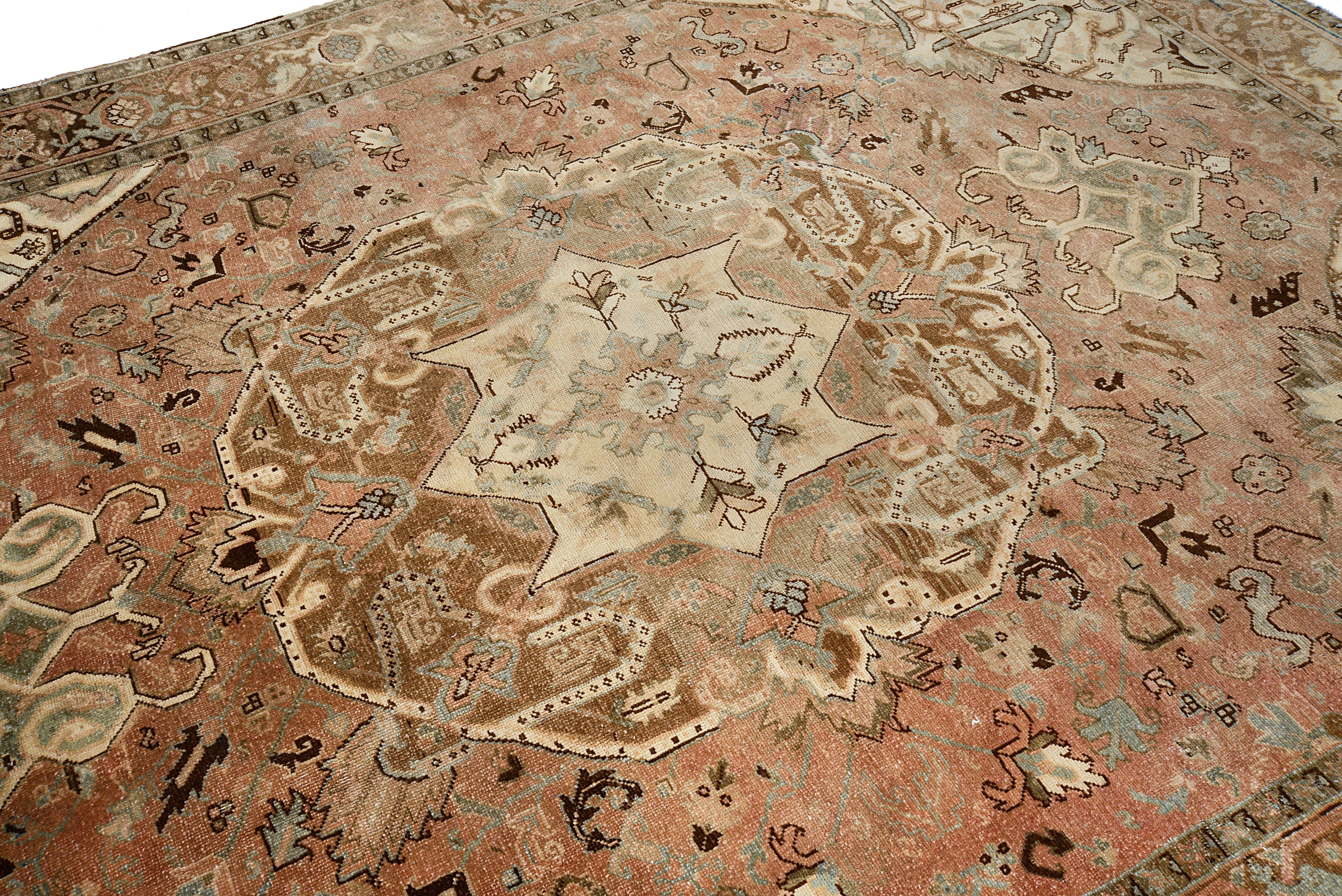 Close-up details of vintage Persian Heriz carpet showing wool texture, motifs, and natural patina
