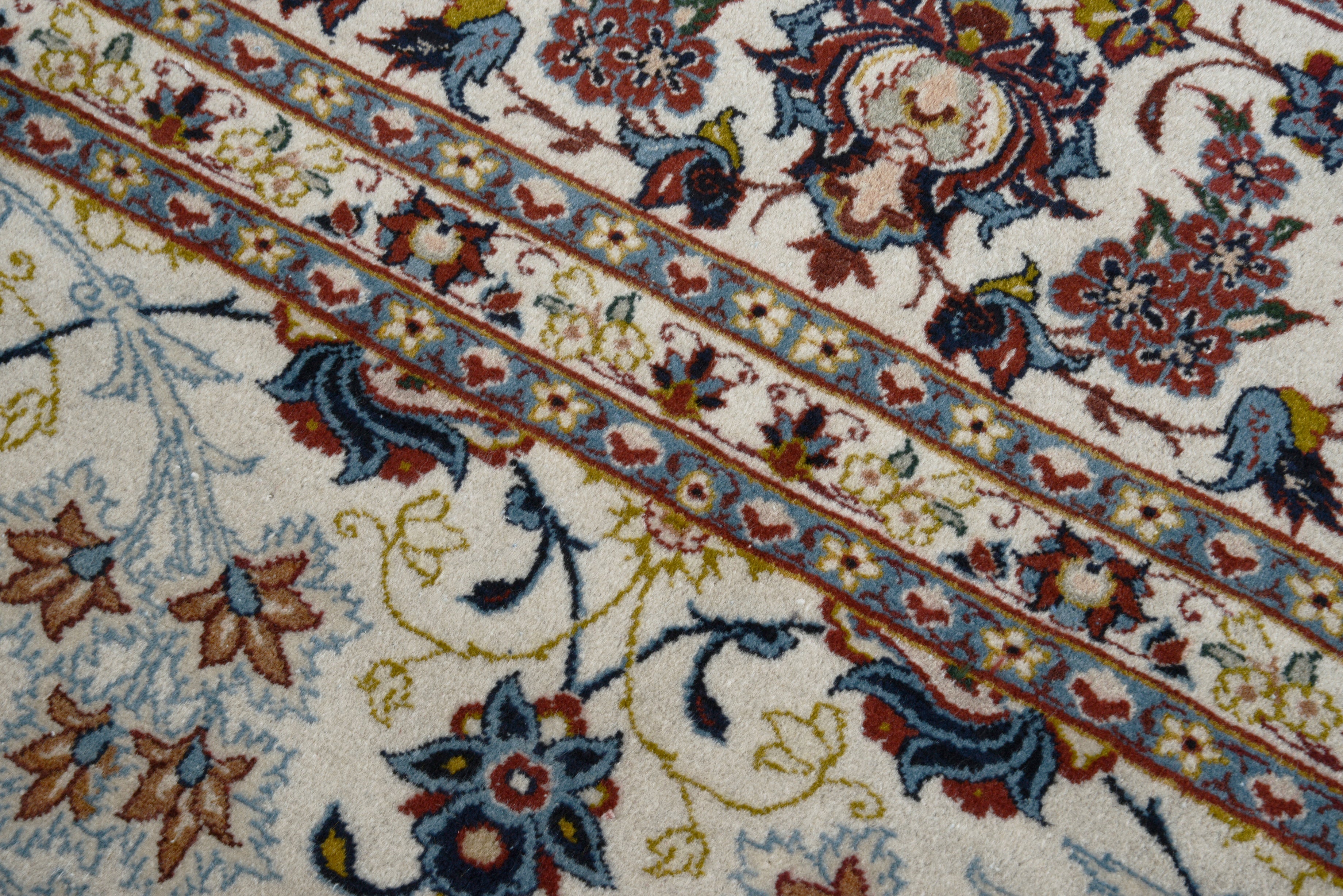Close-up details of fine antique Persian Kashan rug showing silk warp fringes, wool texture, and aged patina
