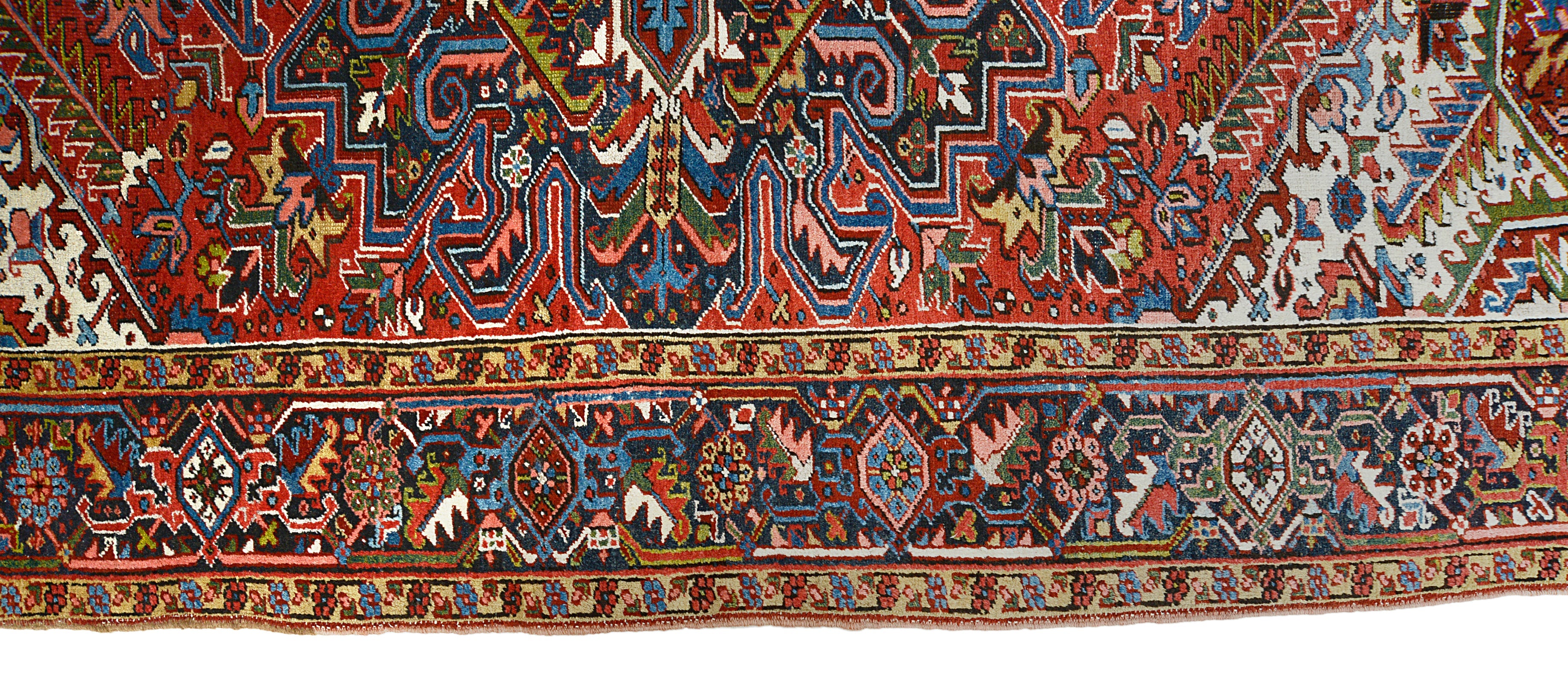 Close-up details of antique Persian Heriz carpet showing wool texture, motifs, and aged patina

