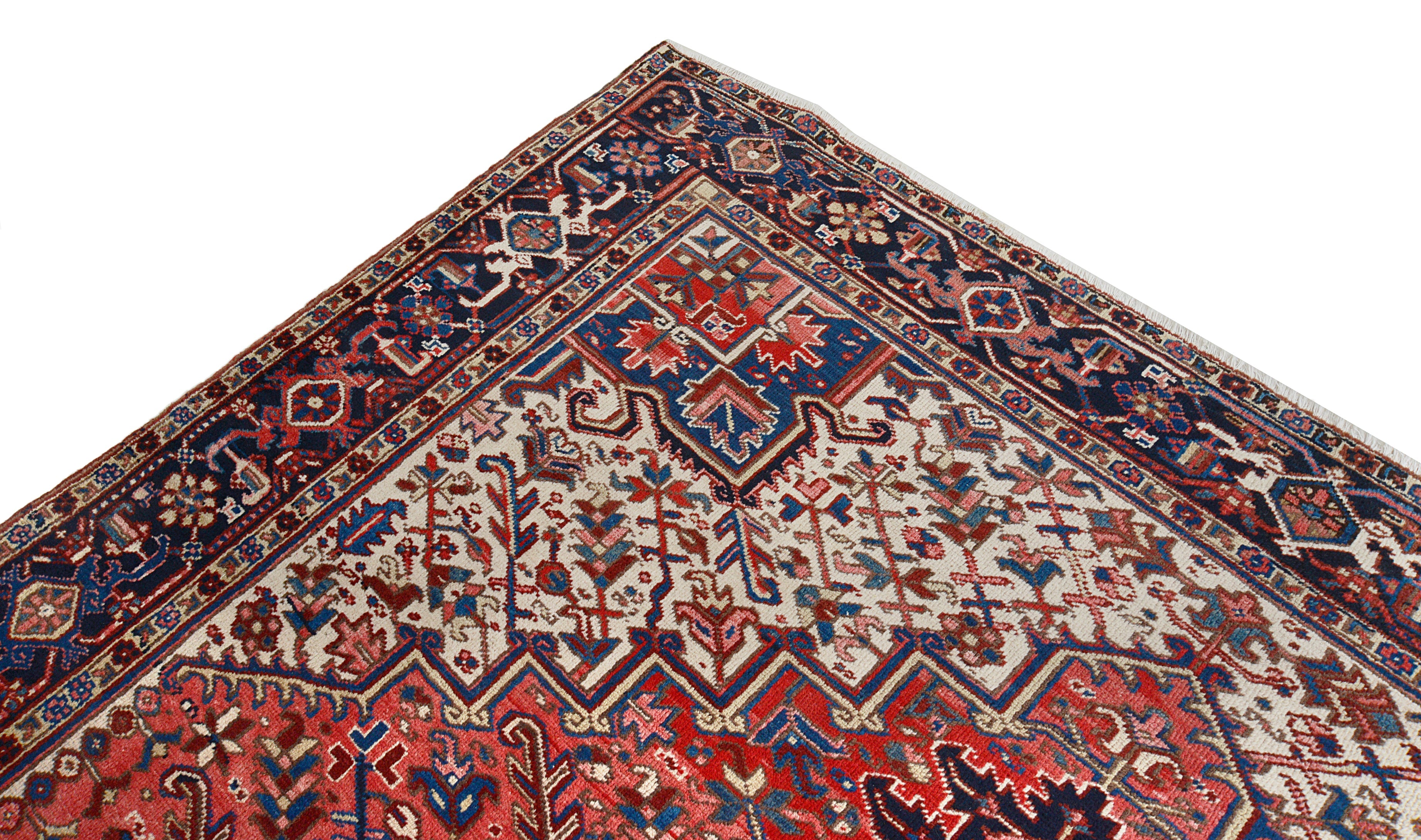 Close-up details of vintage Heriz carpet showing wool texture, motifs, and natural patina
