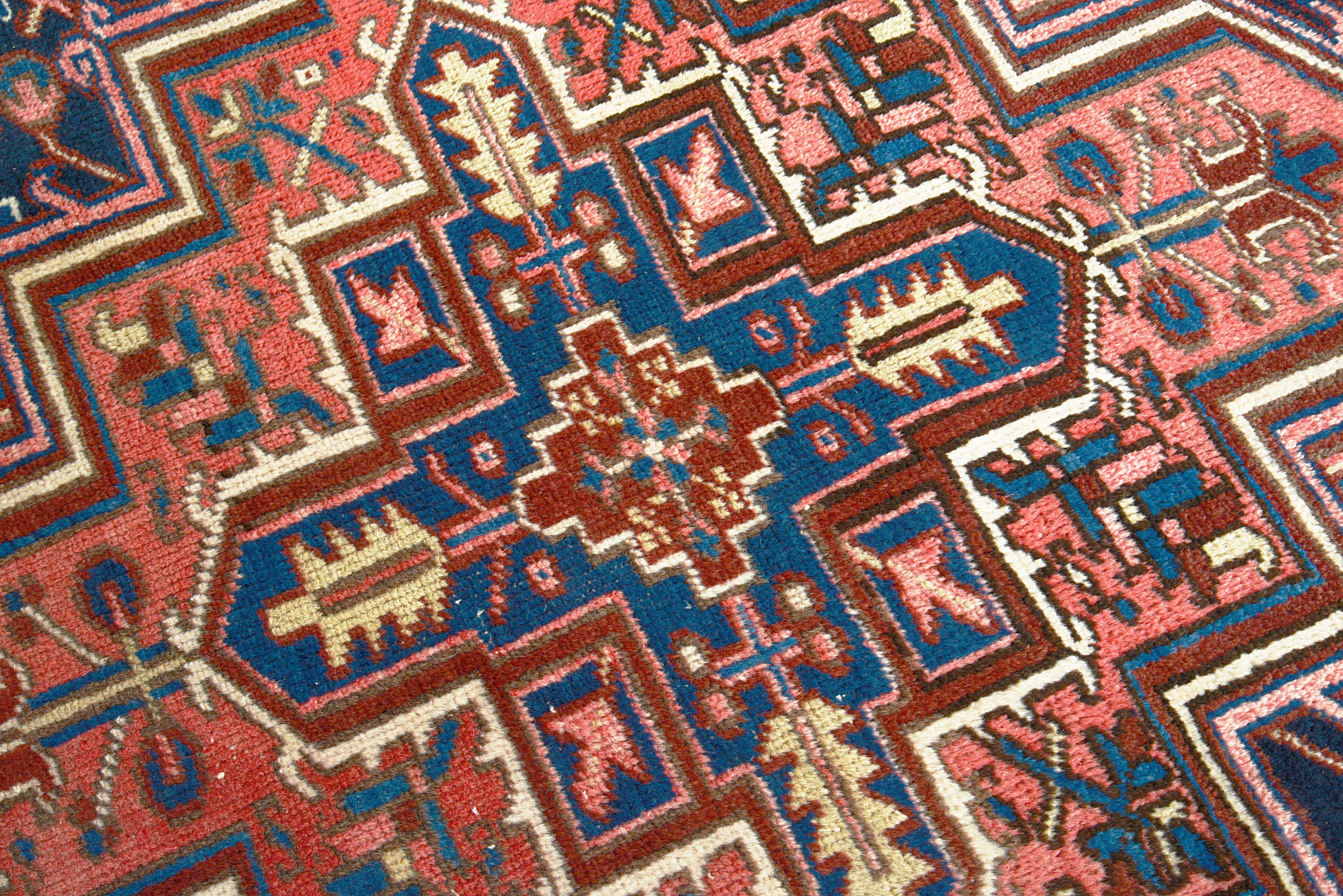 Close-up details of vintage Heriz carpet showing wool texture, motifs, and natural patina
