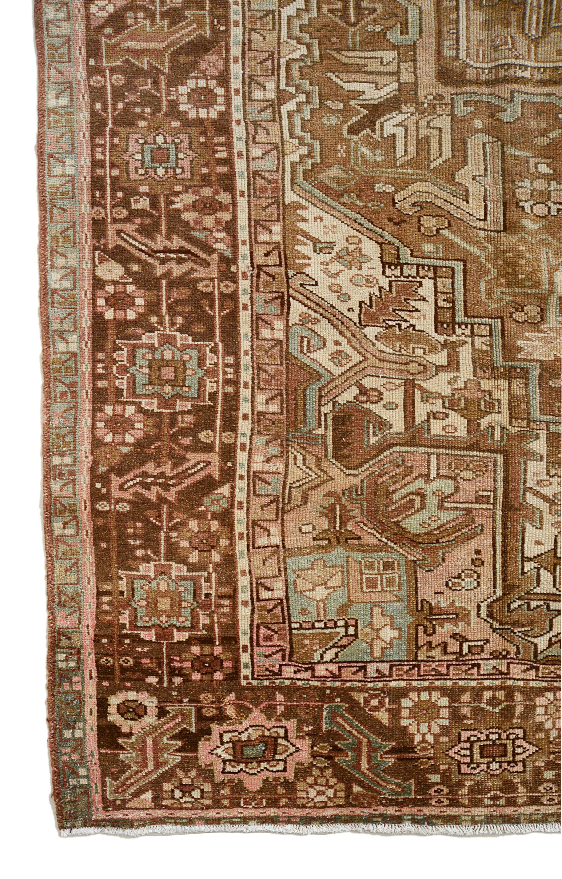 Vintage Persian Heriz carpet corner detail showing hand-knotted wool and geometric border
