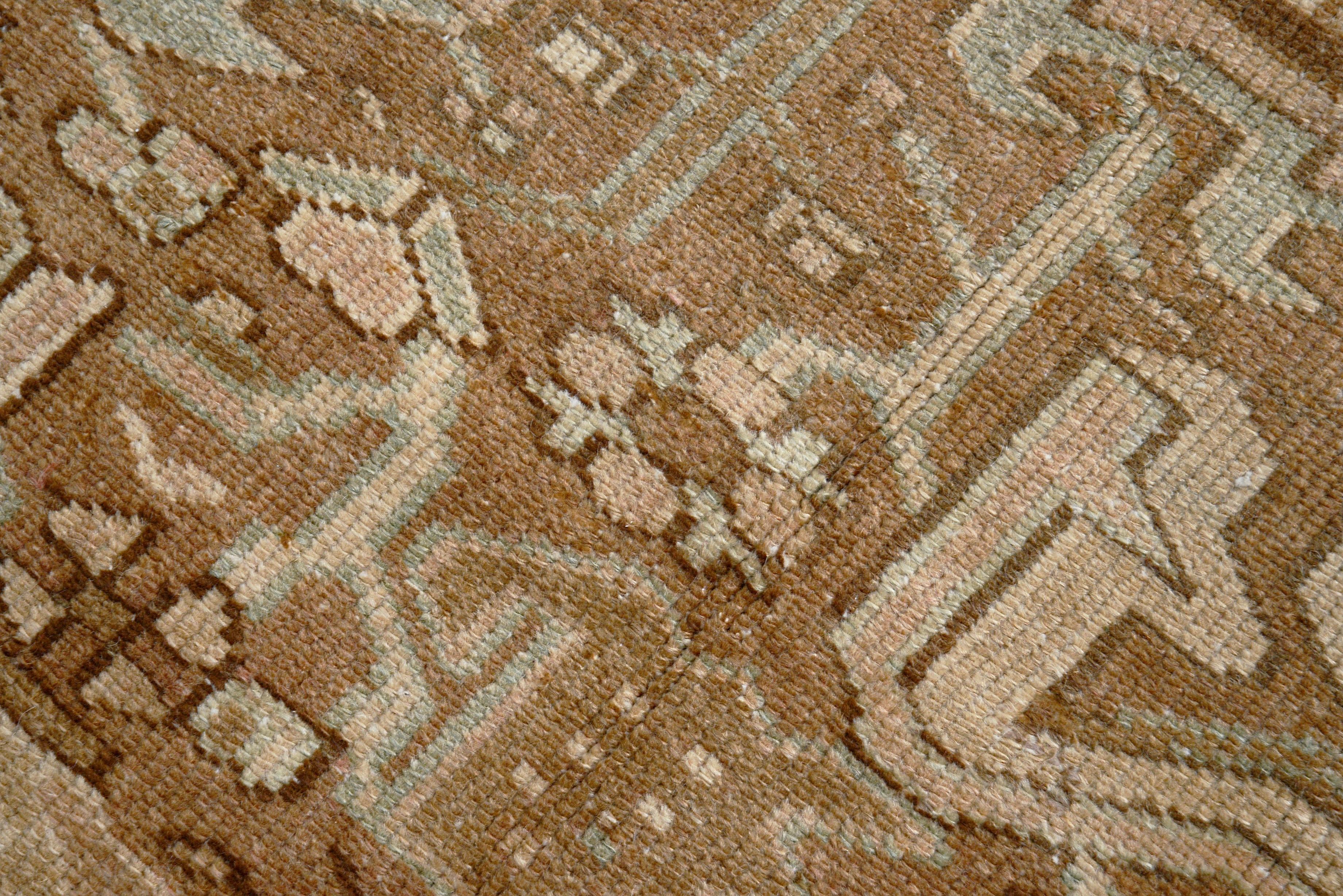 Close-up details of vintage Persian Heriz carpet showing wool texture, motifs, and natural patina
