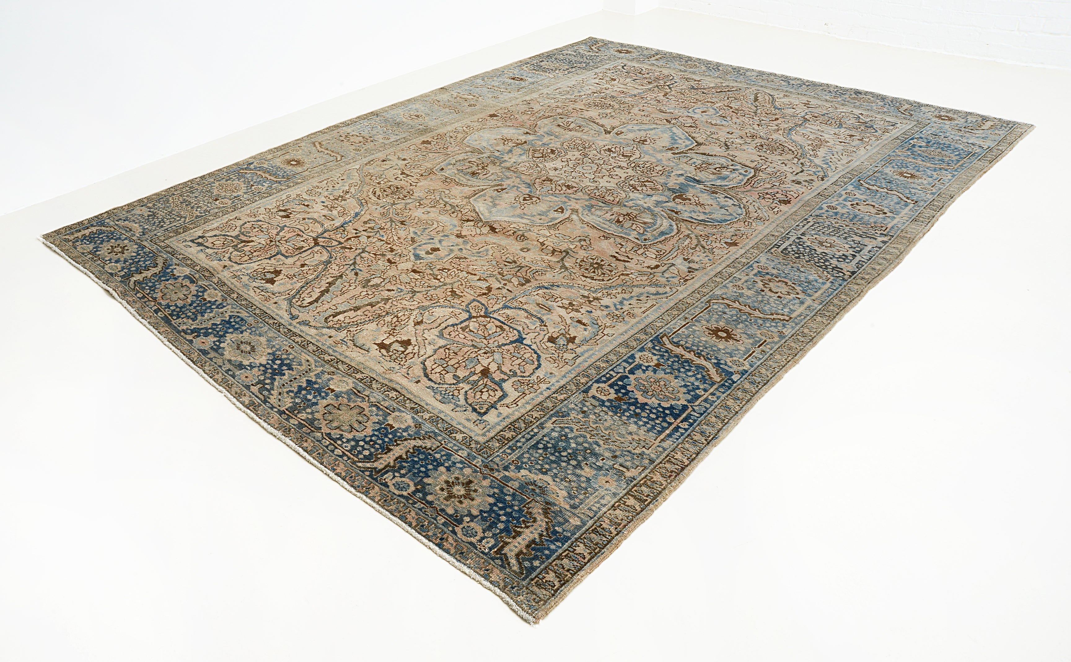 Large vintage Heriz carpet from Persia featuring architectural pattern and aged blue tones
