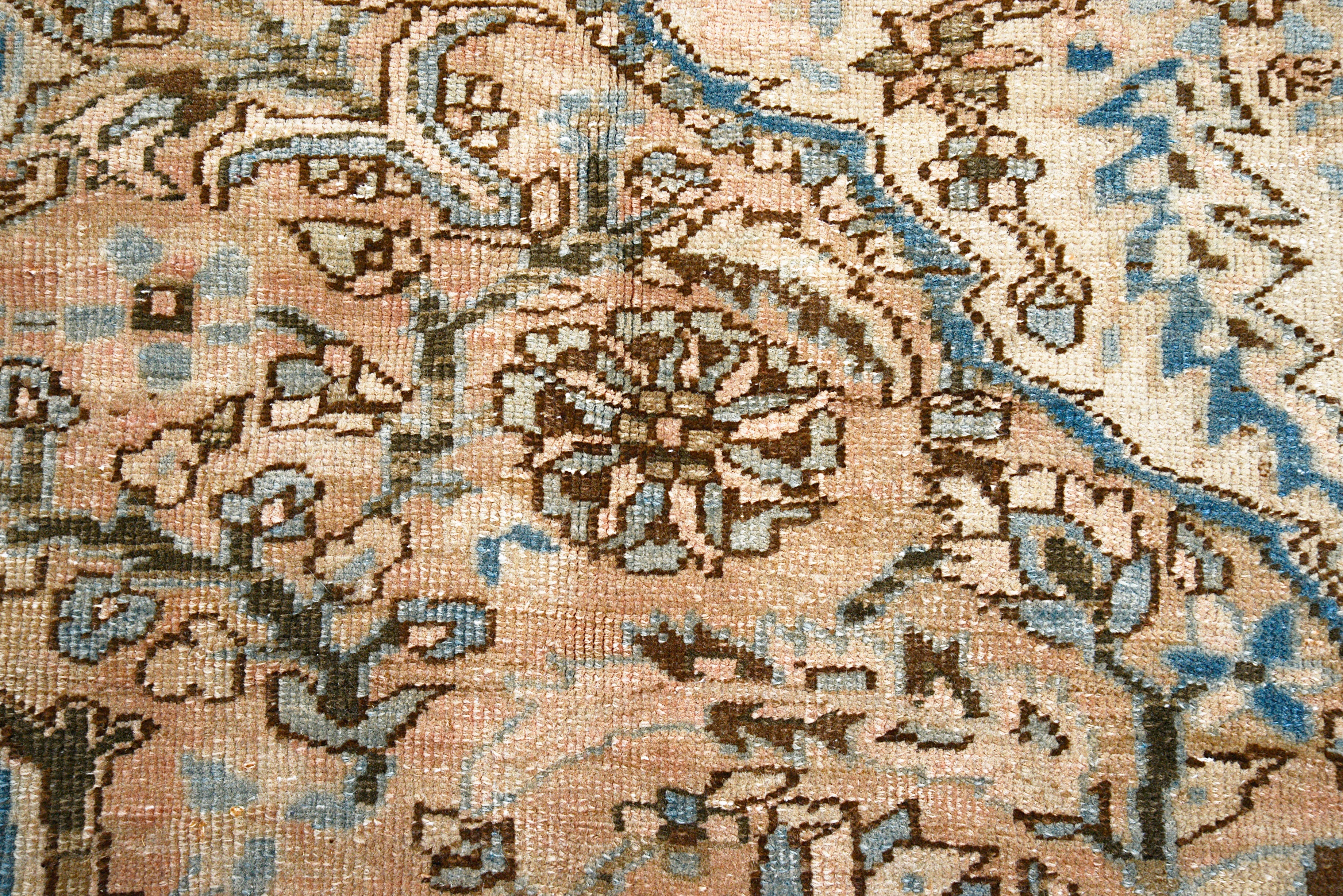 Close-up details of vintage Persian Heriz carpet showing wool texture, motifs, and natural patina
