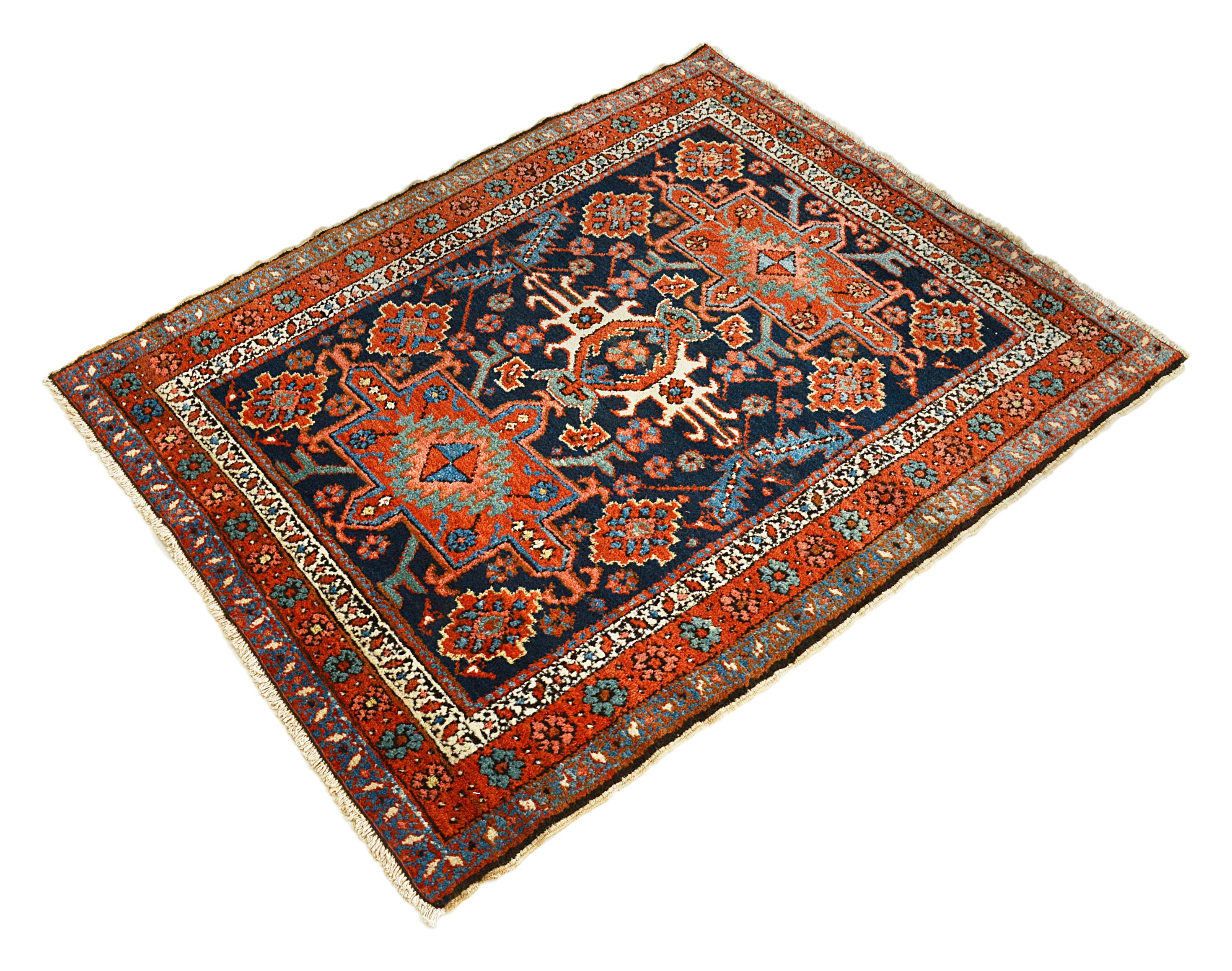 Small antique Heriz rug from Persia featuring strong geometric design and aged patina
