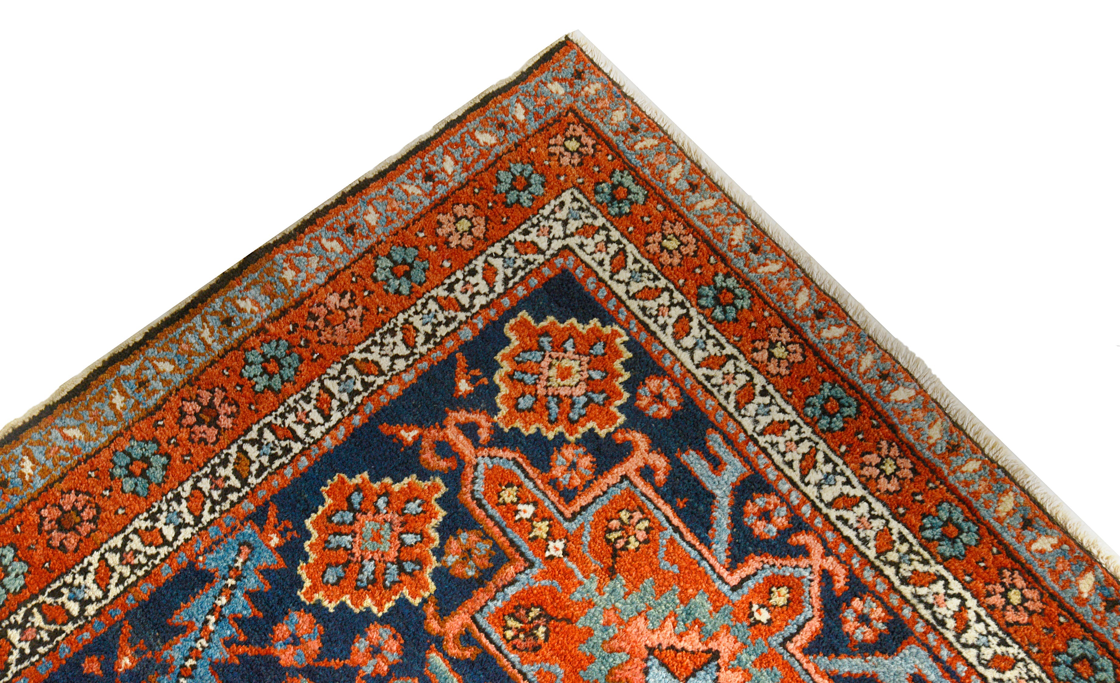 Close-up details of antique Persian Heriz rug showing wool texture, motifs, and natural ageing
