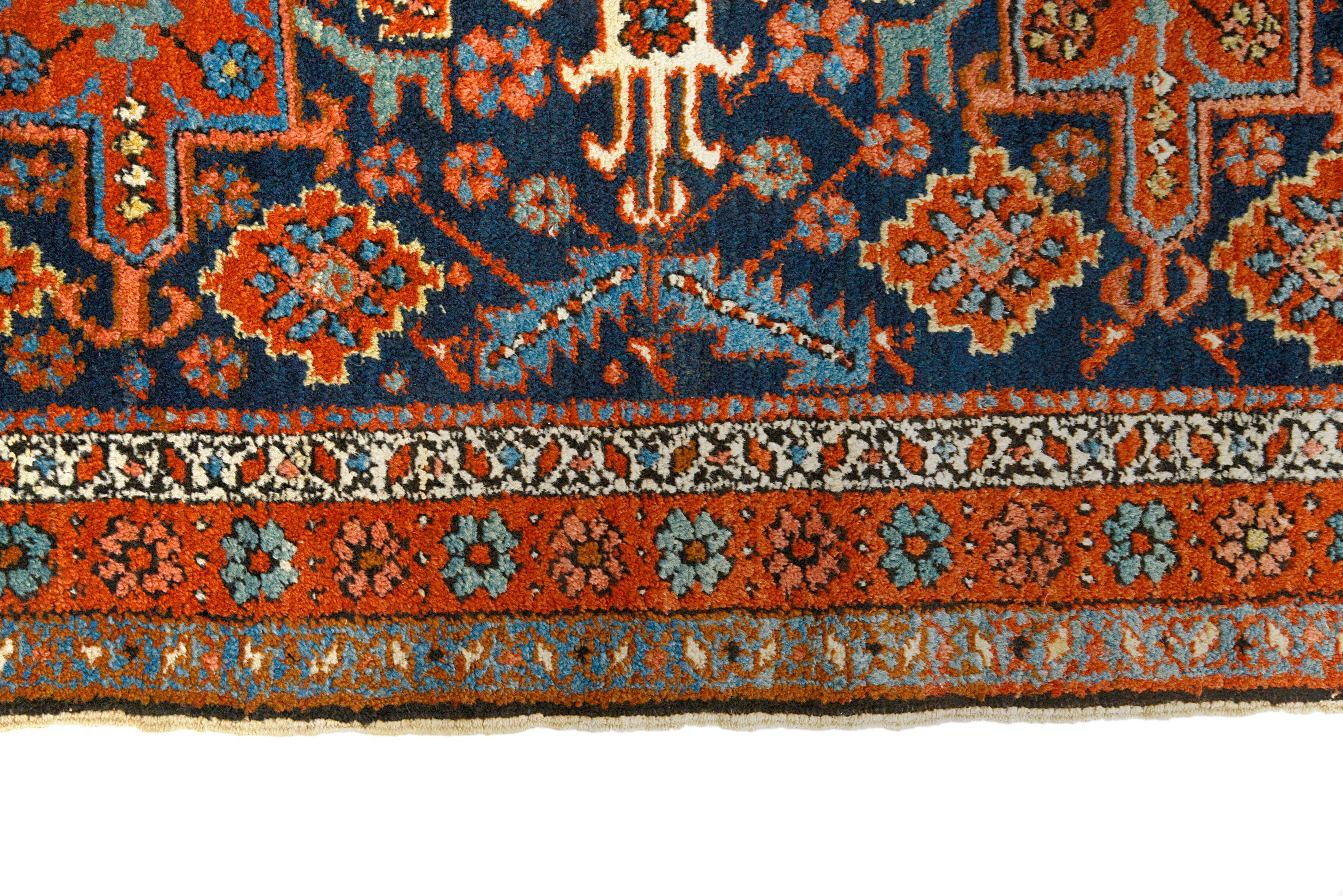 Close-up details of antique Persian Heriz rug showing wool texture, motifs, and natural ageing

