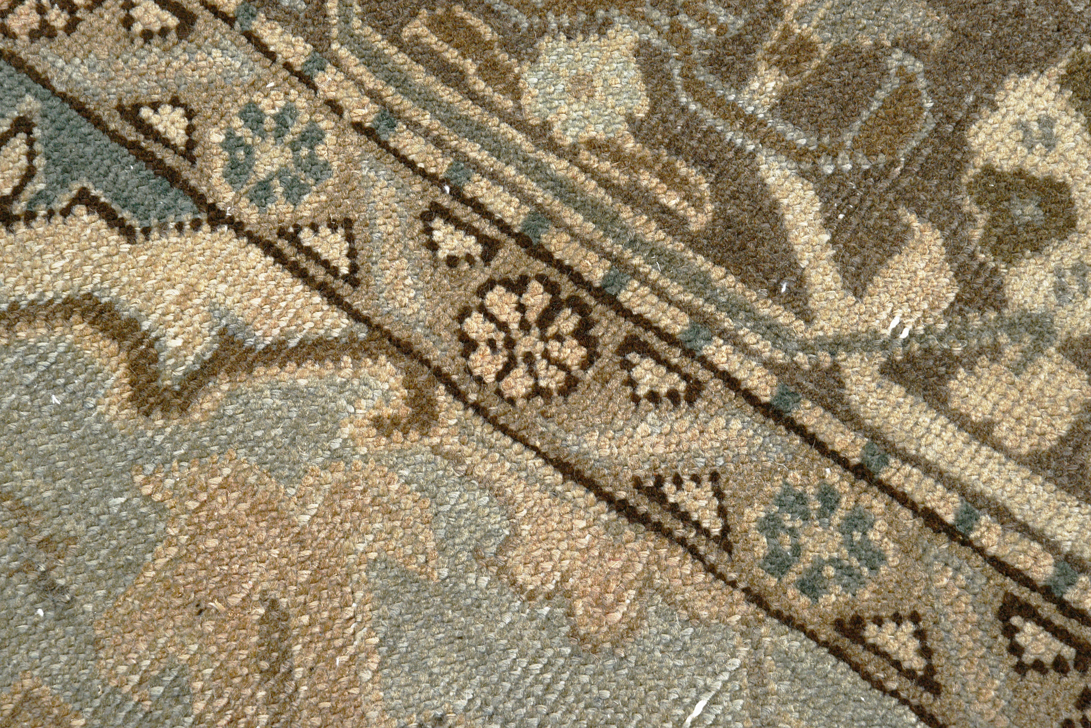 Close-up details of vintage Persian Heriz rug showing wool texture, motifs, and natural patina
