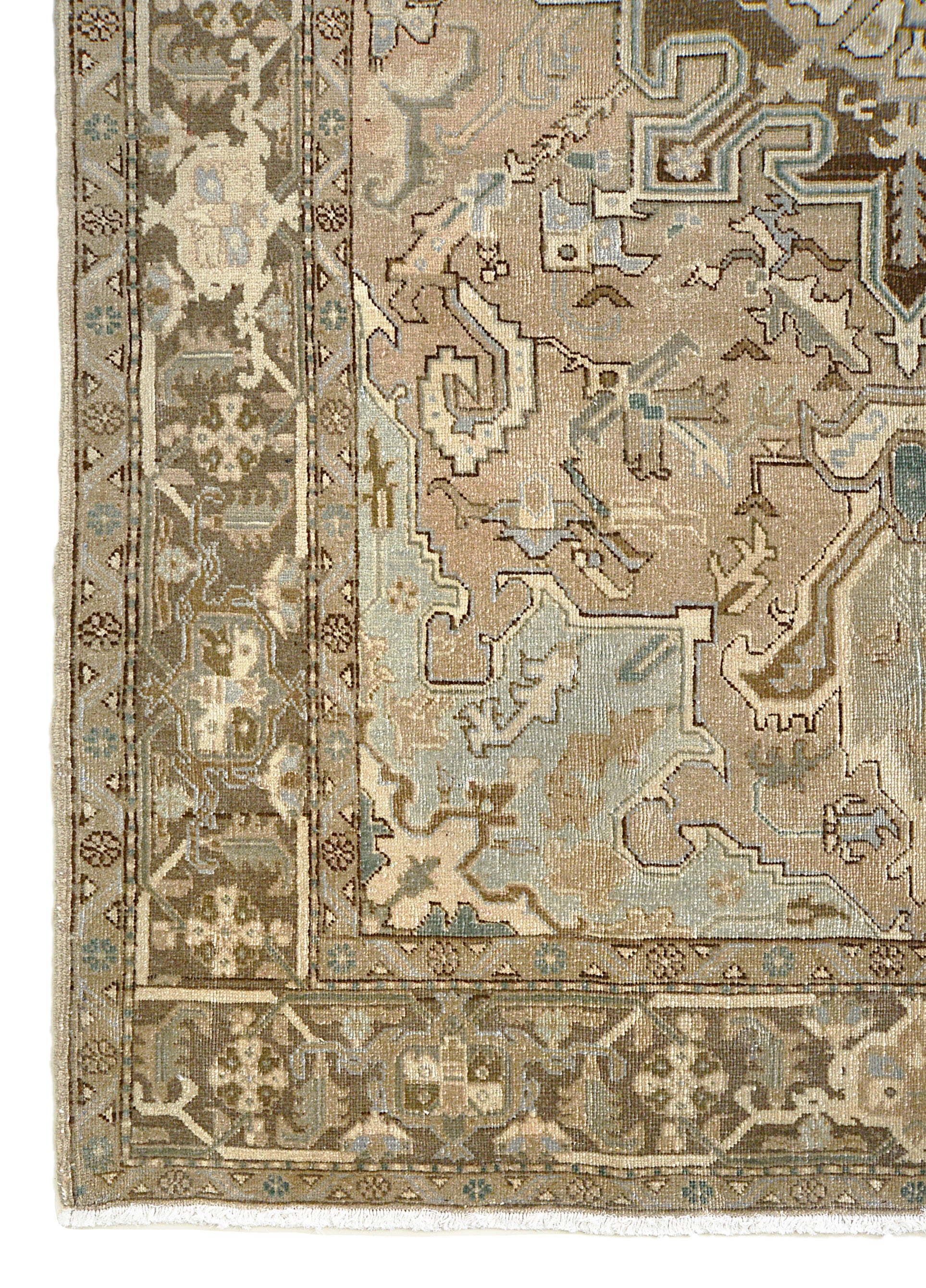 Vintage Persian Heriz rug corner detail showing hand-knotted wool and geometric floral border
