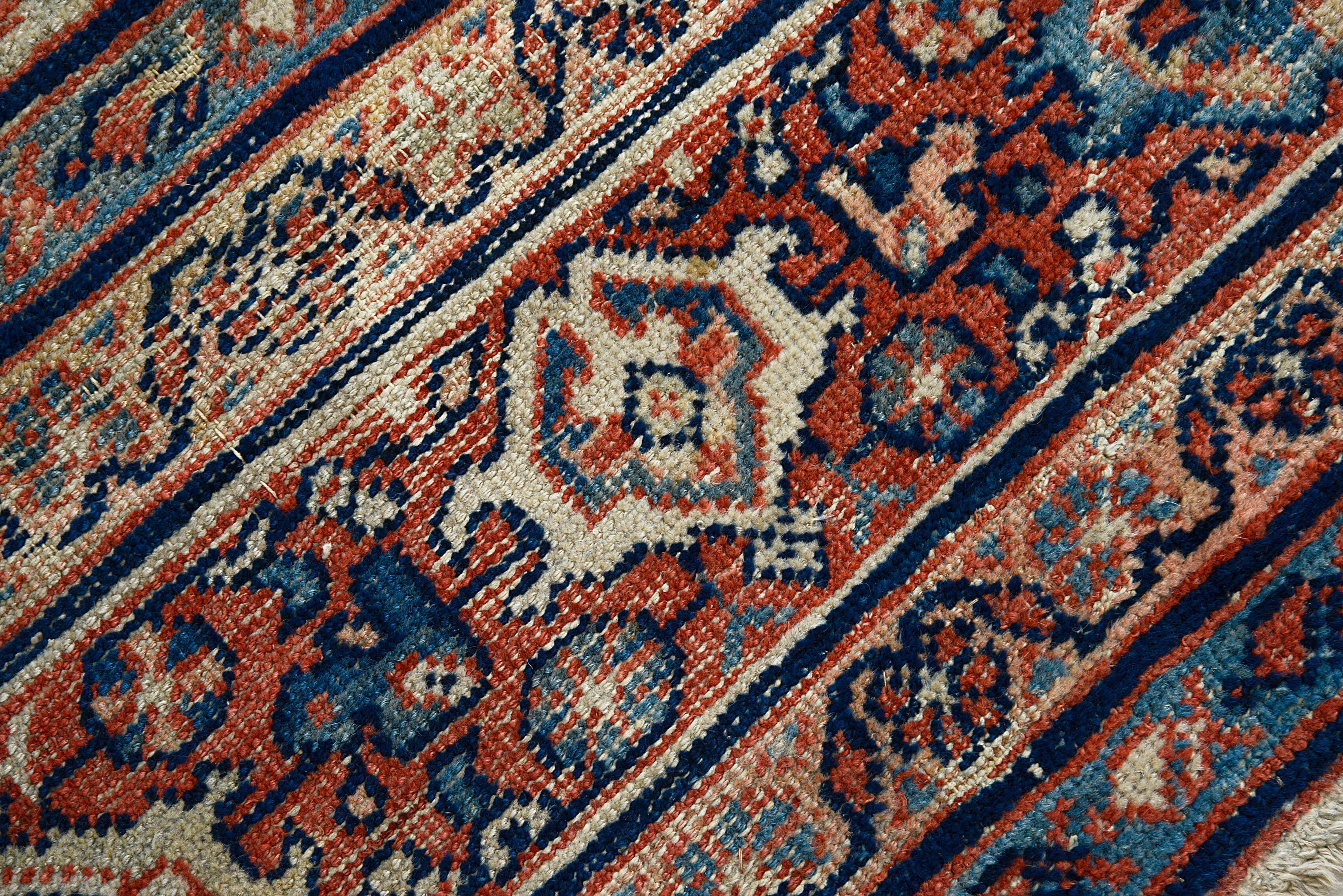 Detailed view of antique Persian Mahal rug showing wool texture and age-related character

