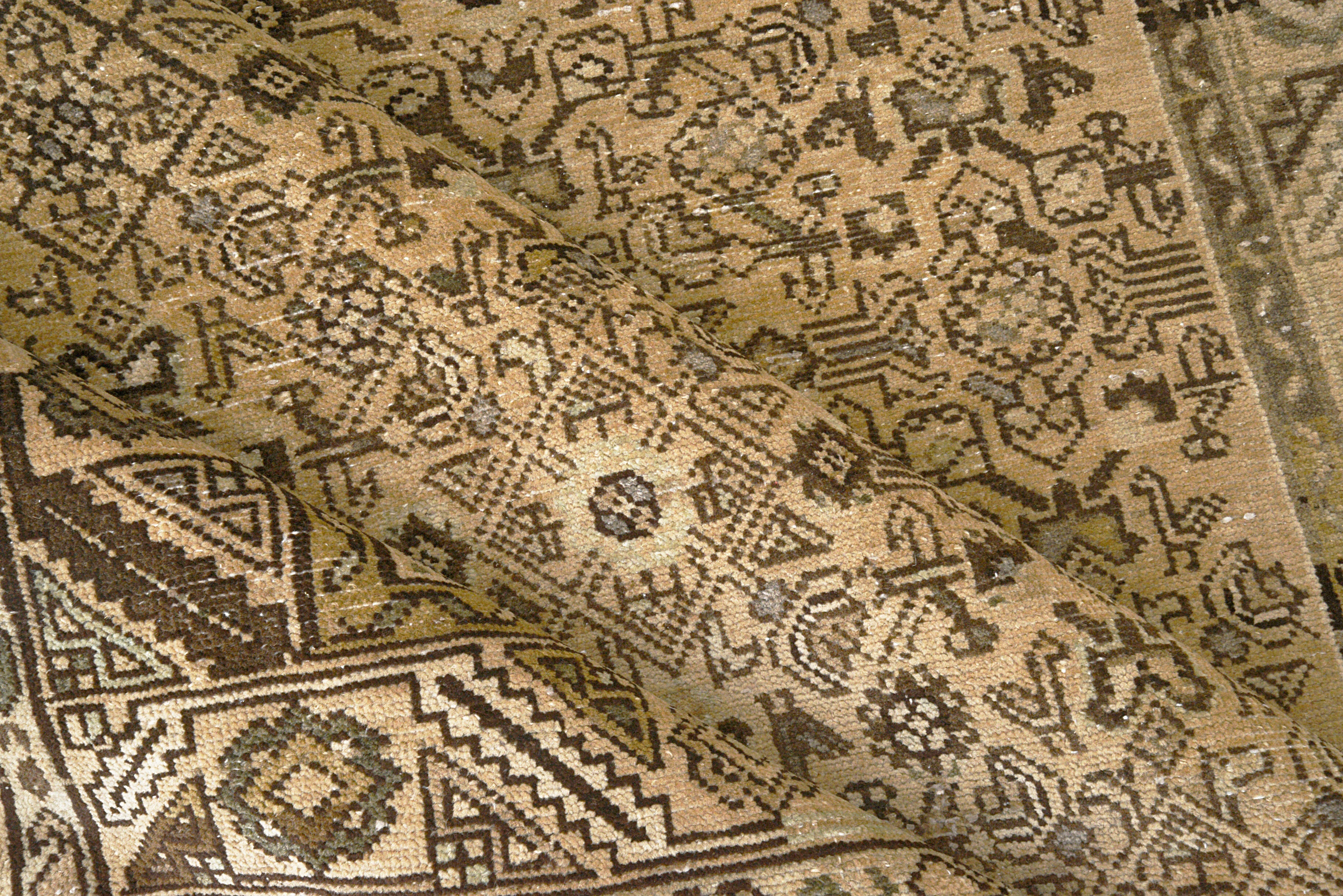 Close-up details of vintage Persian Malayer rug showing wool texture, borders, and natural patina
