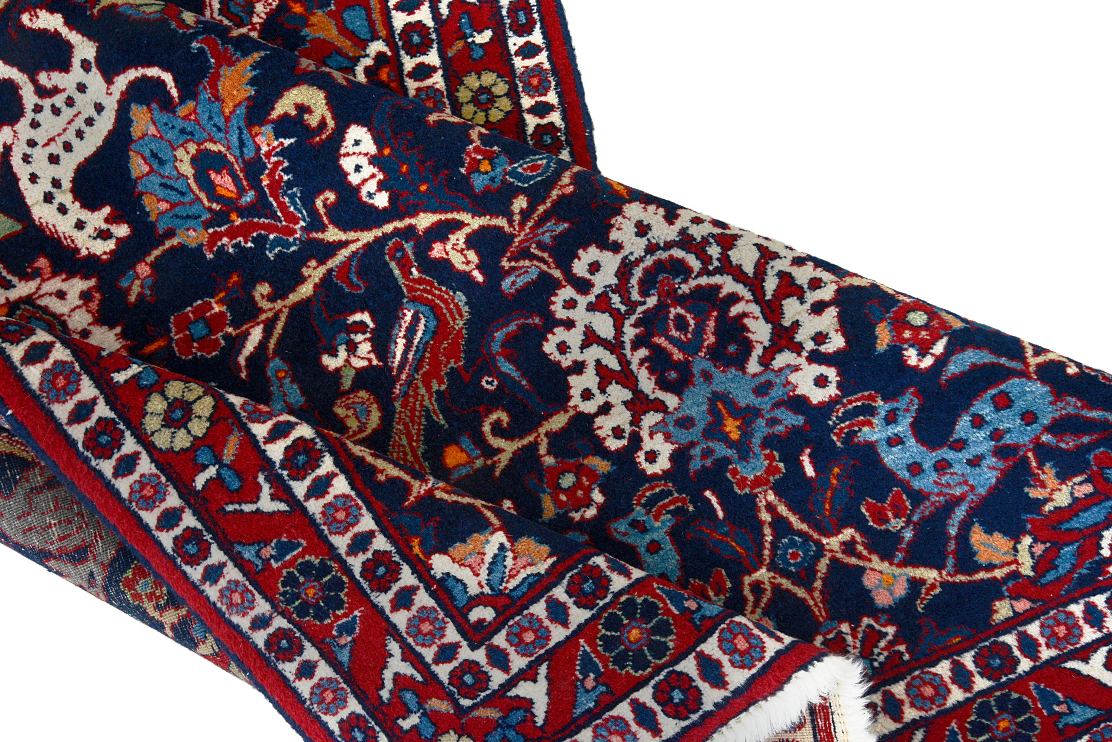 Close-up details of vintage Persian Mashhad rug showing wool texture, motifs, and natural patina
