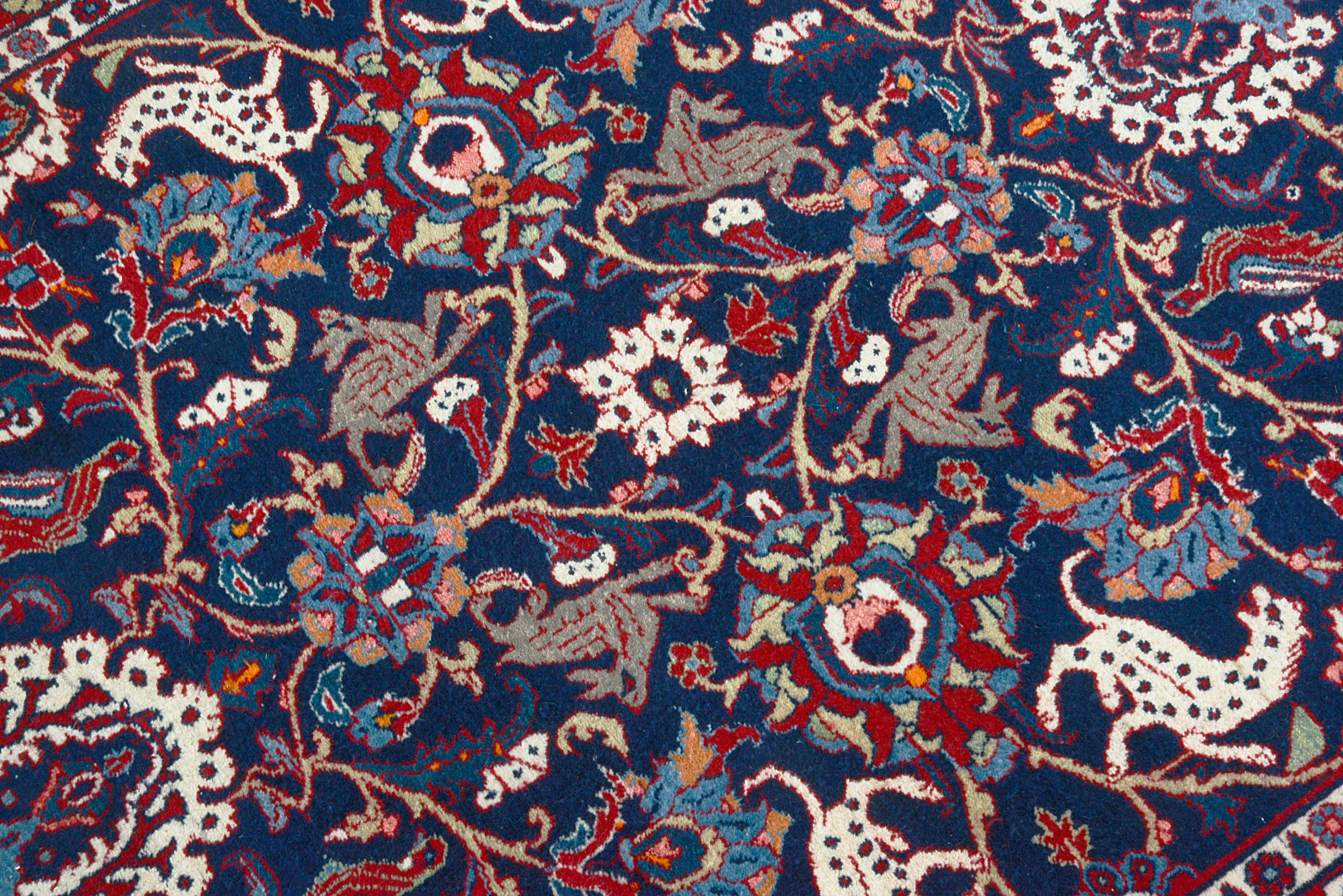 Close-up details of vintage Persian Mashhad rug showing wool texture, motifs, and natural patina
