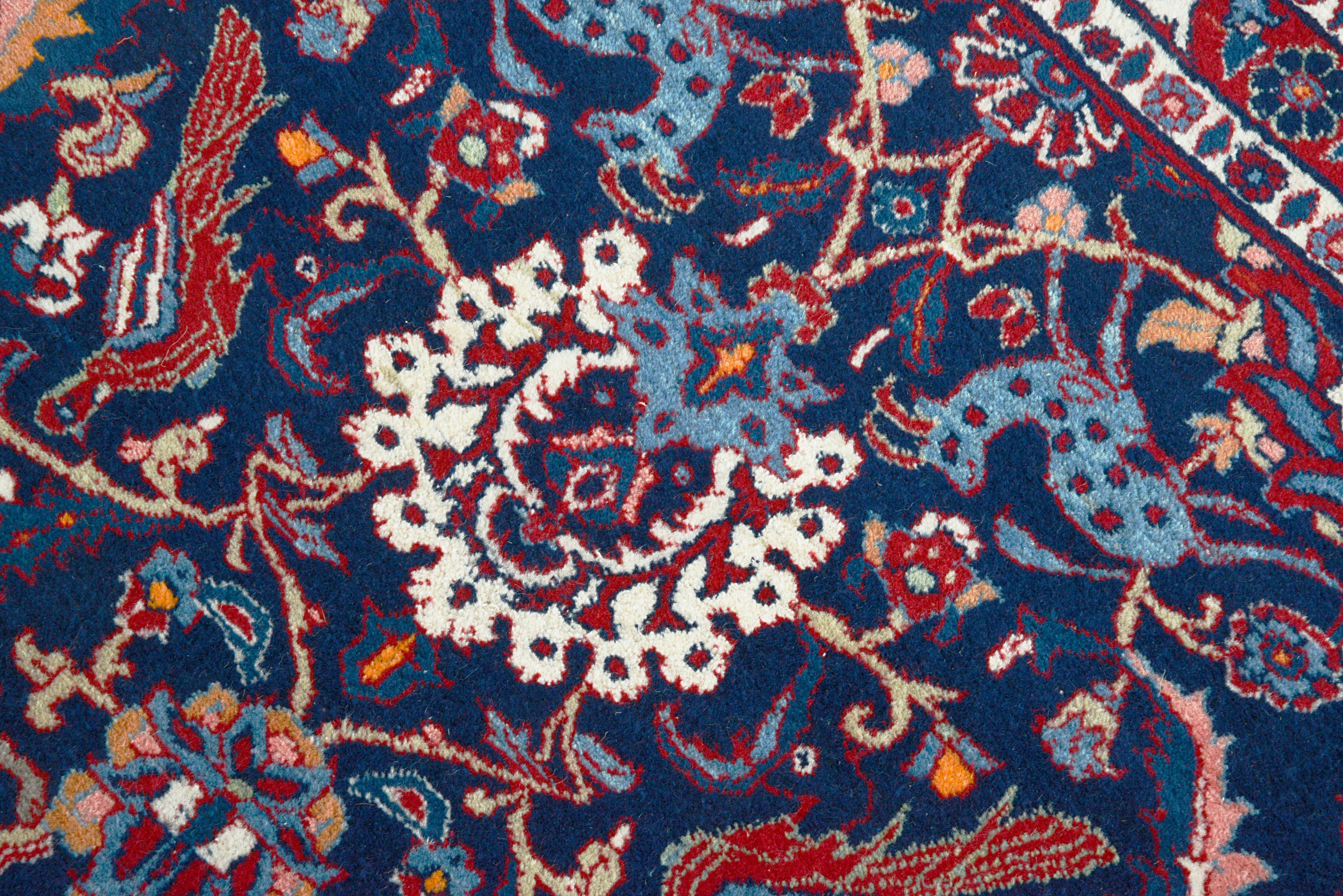 Close-up details of vintage Persian Mashhad rug showing wool texture, motifs, and natural patina
