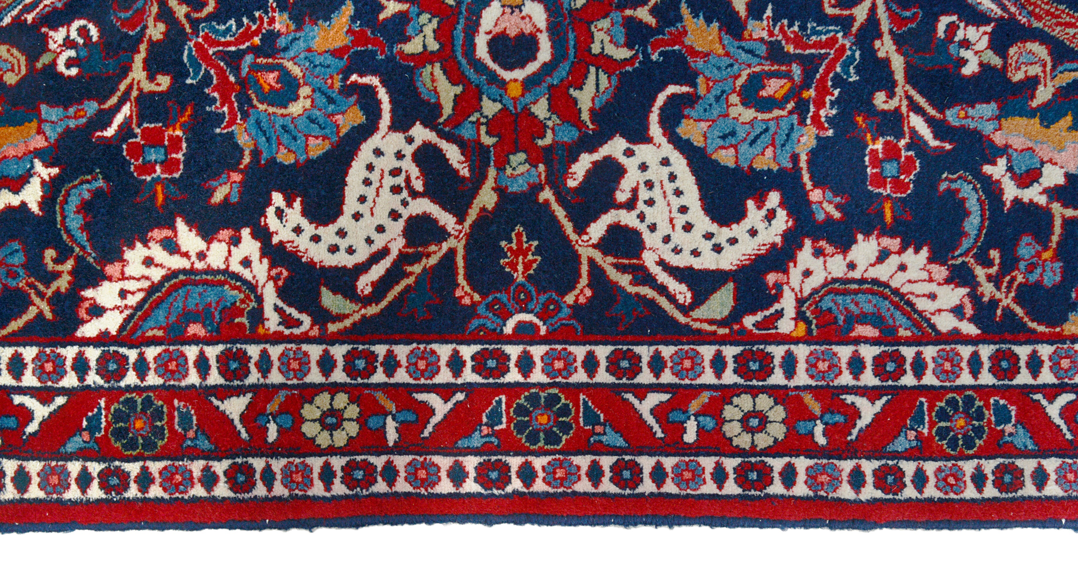 Close-up details of vintage Persian Mashhad rug showing wool texture, motifs, and natural patina
