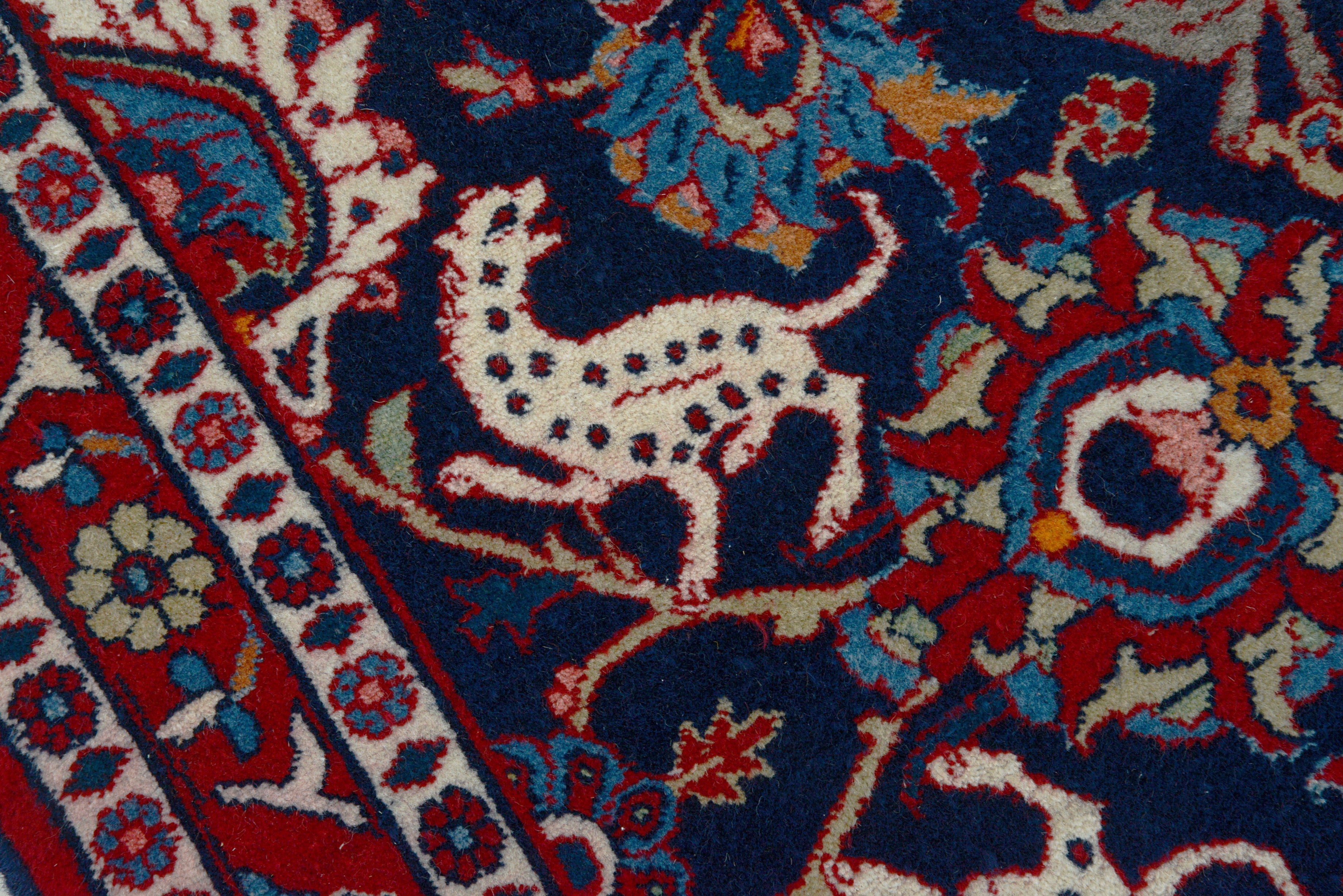 Close-up details of vintage Persian Mashhad rug showing wool texture, motifs, and natural patina
