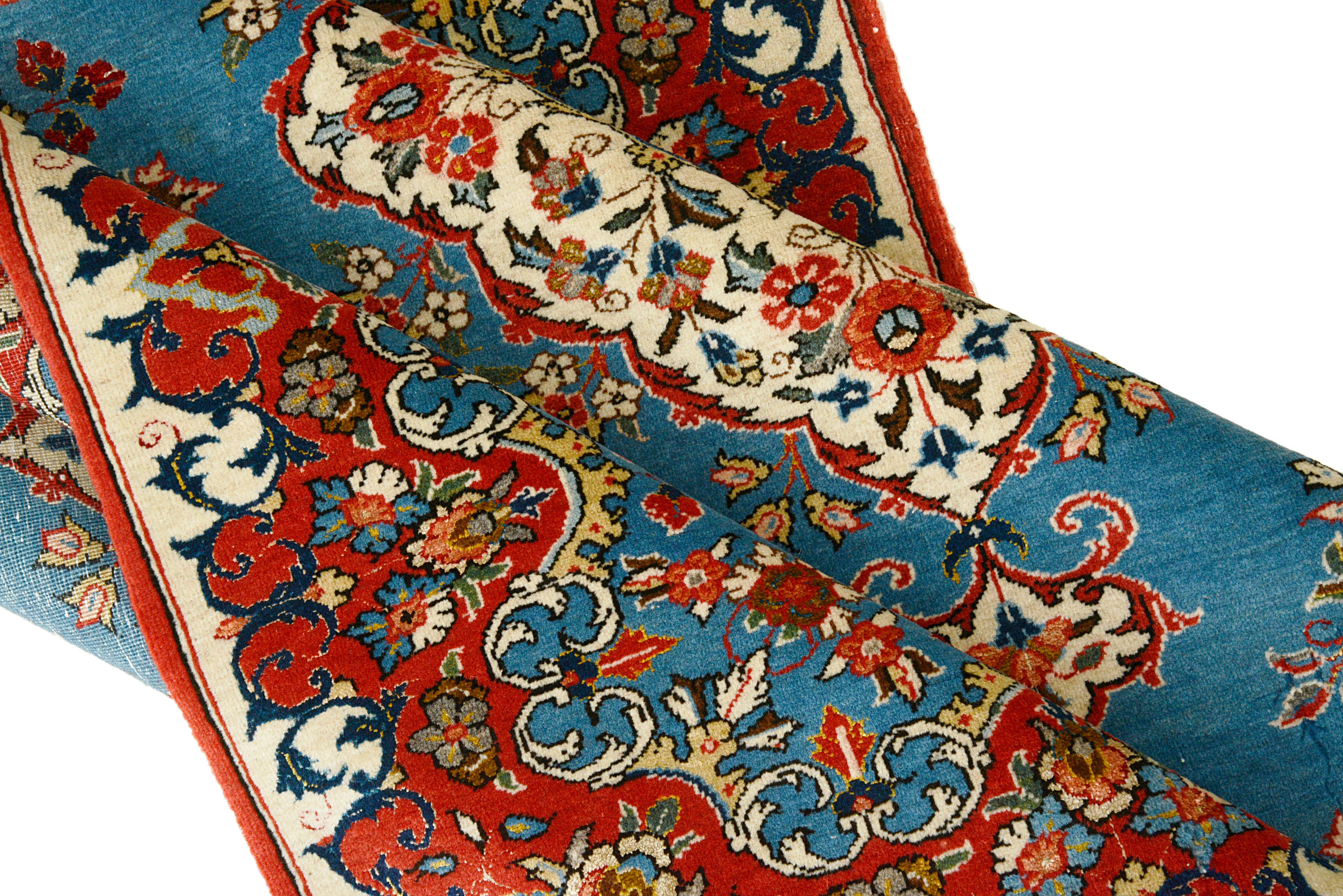 Close-up details of fine antique Persian Qom rug showing wool texture, floral motifs, and aged patina
