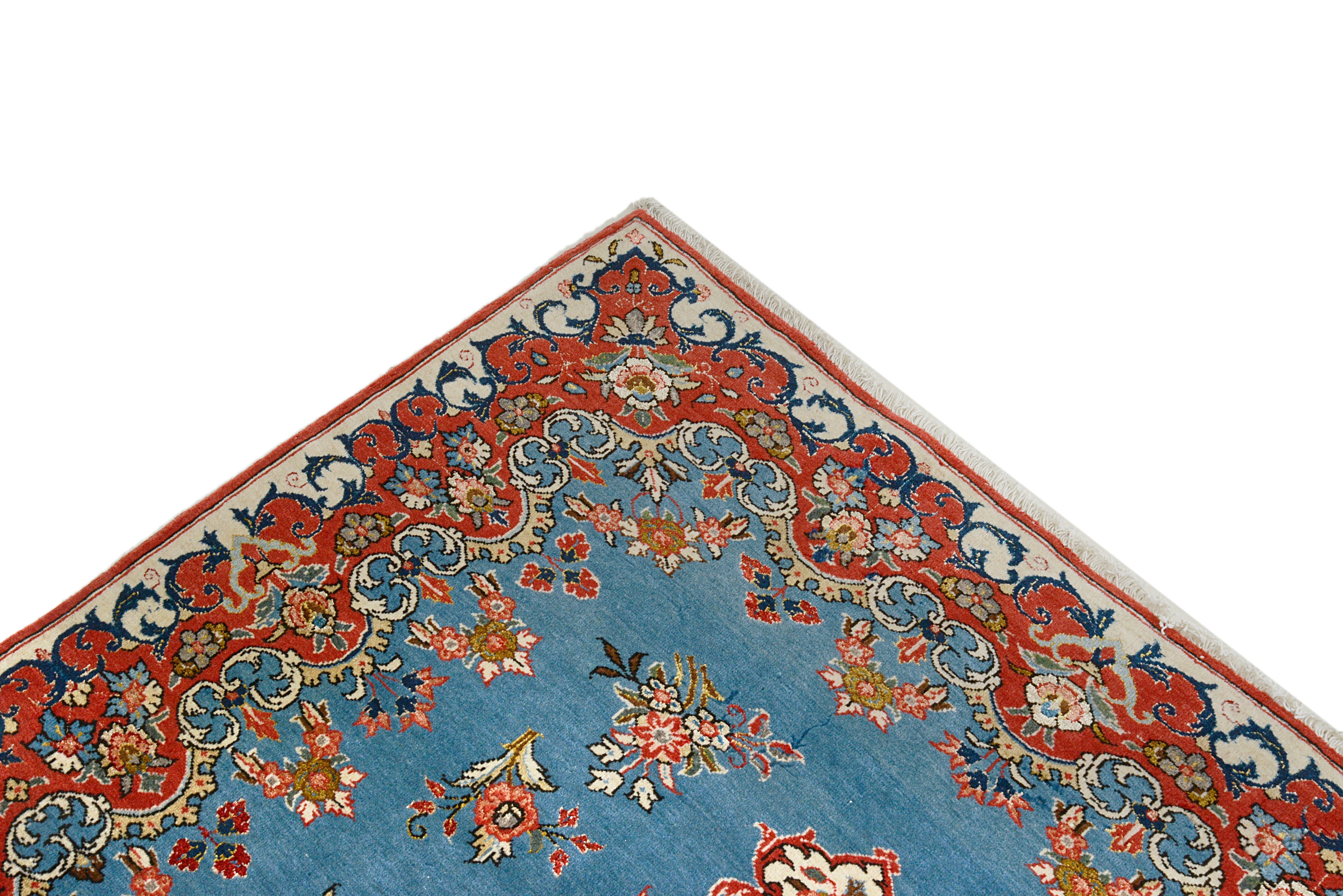 Close-up details of fine antique Persian Qom rug showing wool texture, floral motifs, and aged patina
