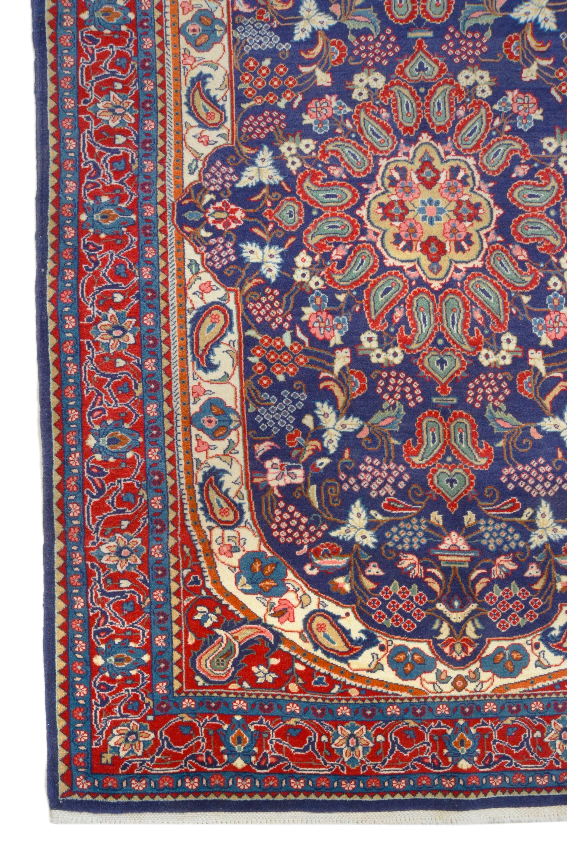 Vintage Persian Sarouk rug corner detail showing hand-knotted wool and floral border
