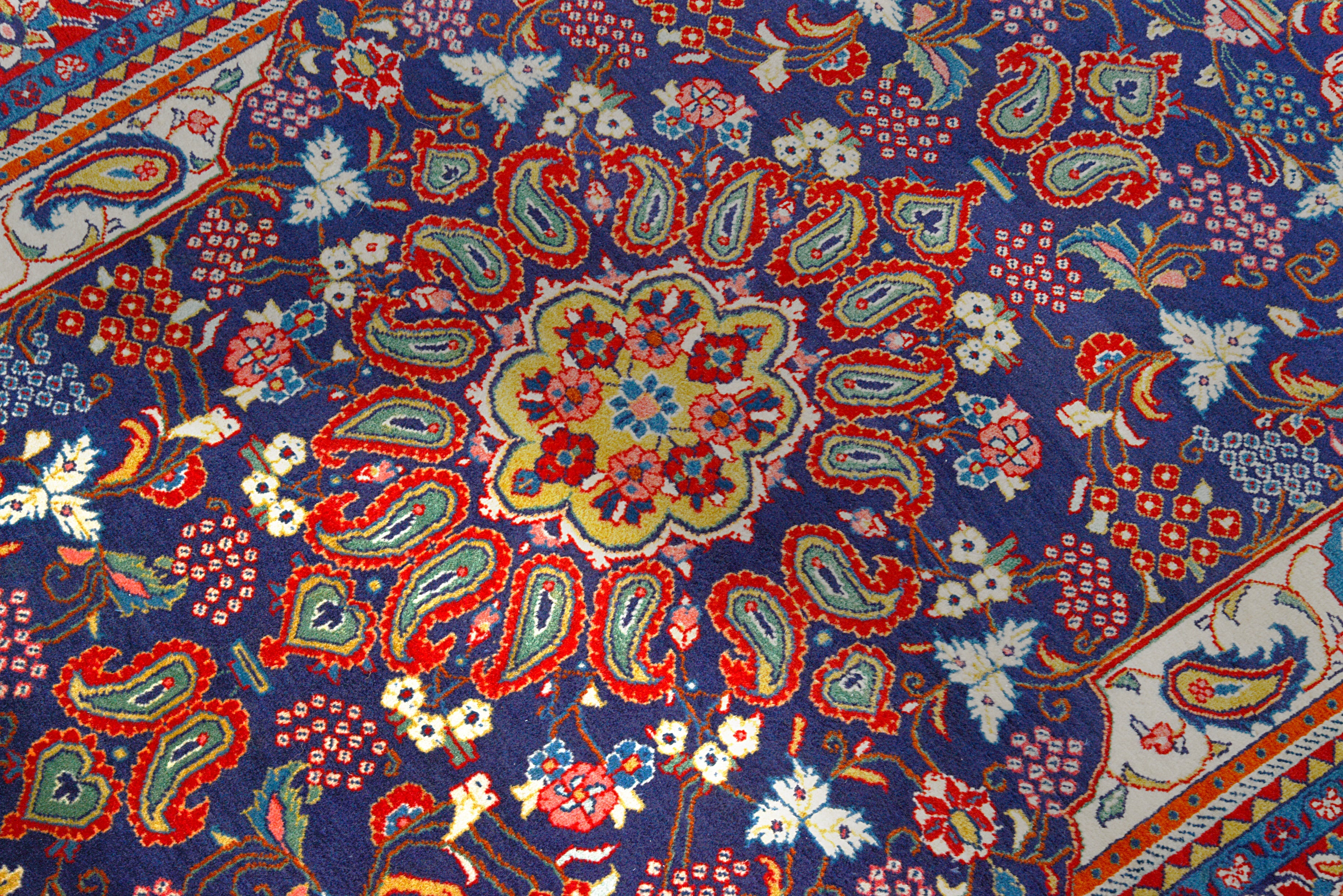 Close-up details of vintage Persian Sarouk rug showing wool texture, motifs, and natural patina
