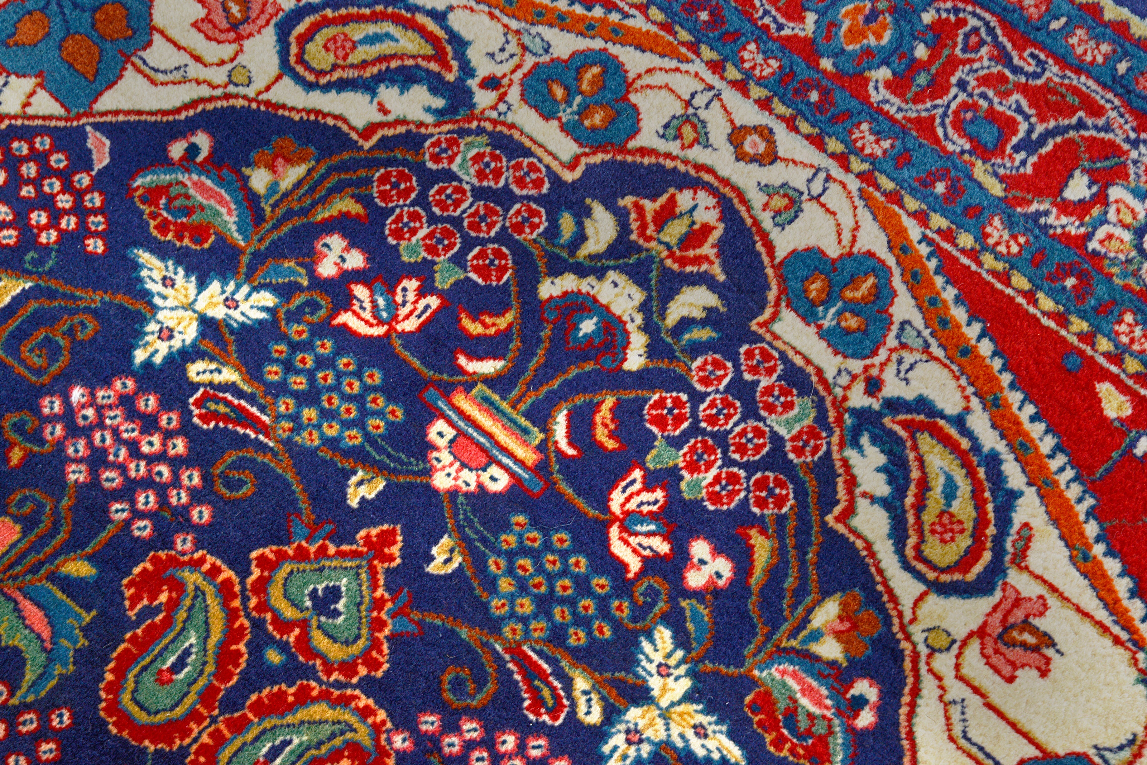 Close-up details of vintage Persian Sarouk rug showing wool texture, motifs, and natural patina
