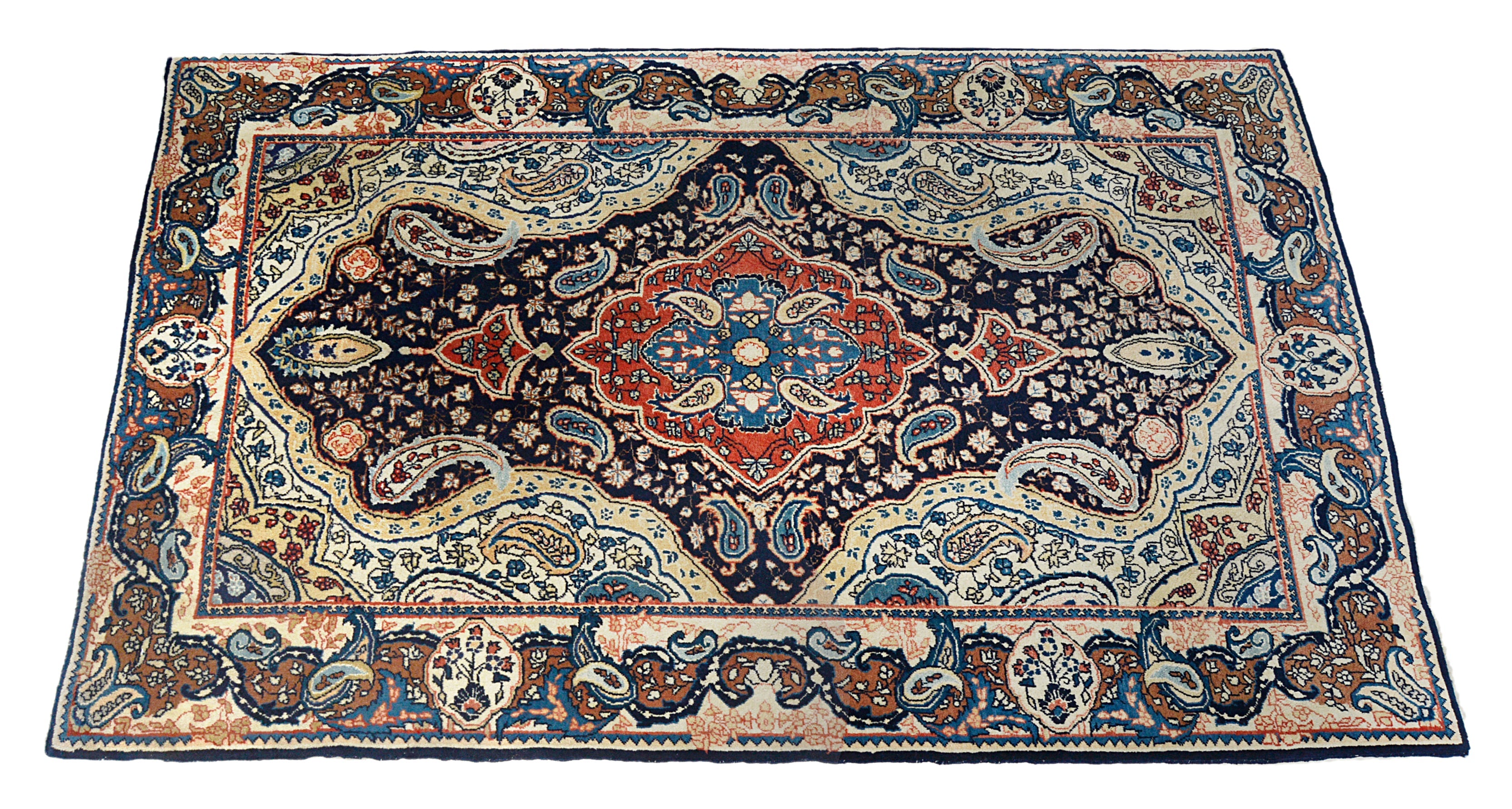 Hand-knotted antique Sarouk rug with central medallion and deep blue field
