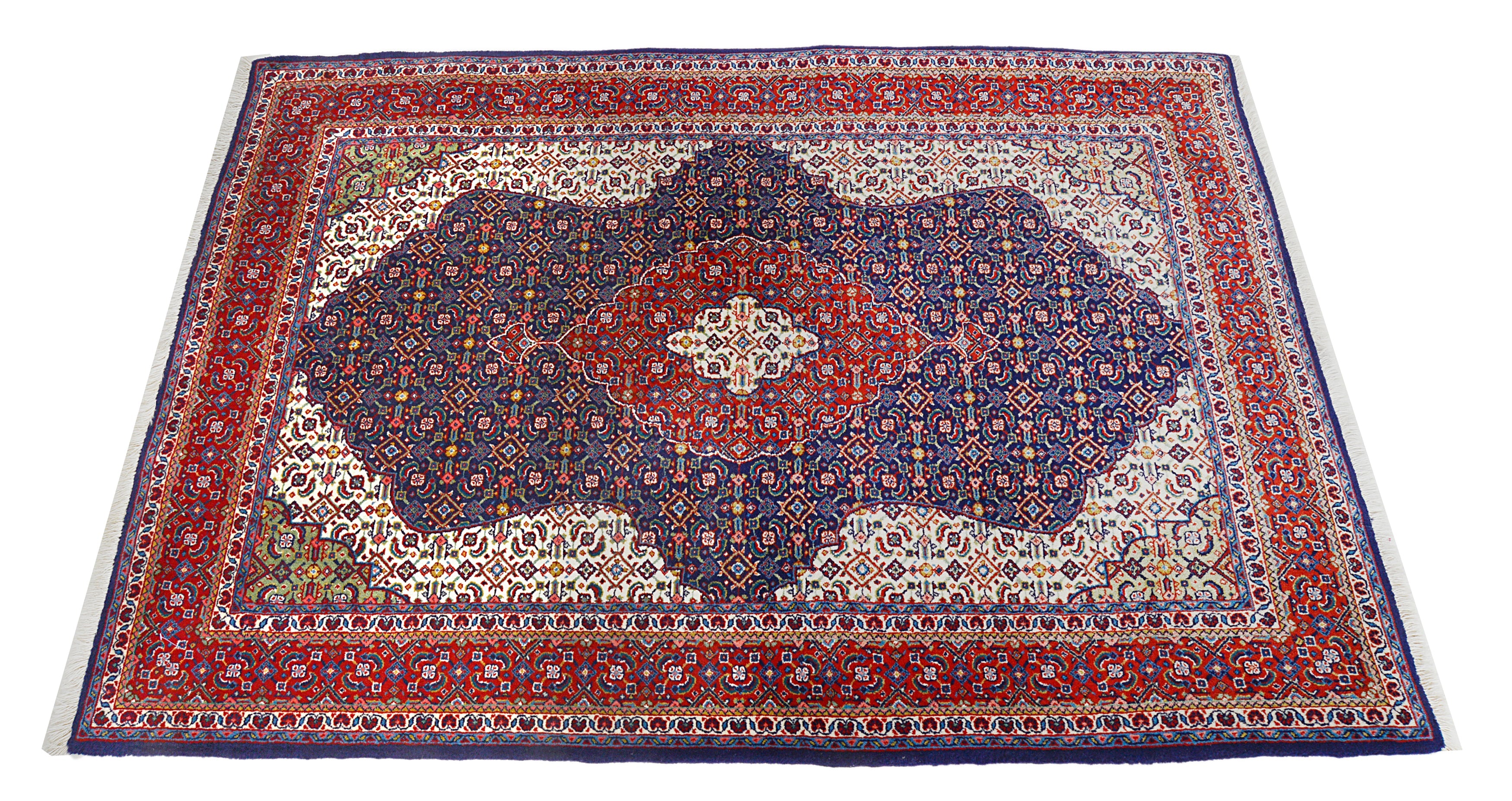 Hand-knotted vintage Sarouk rug with dense floral pattern and deep blue field
