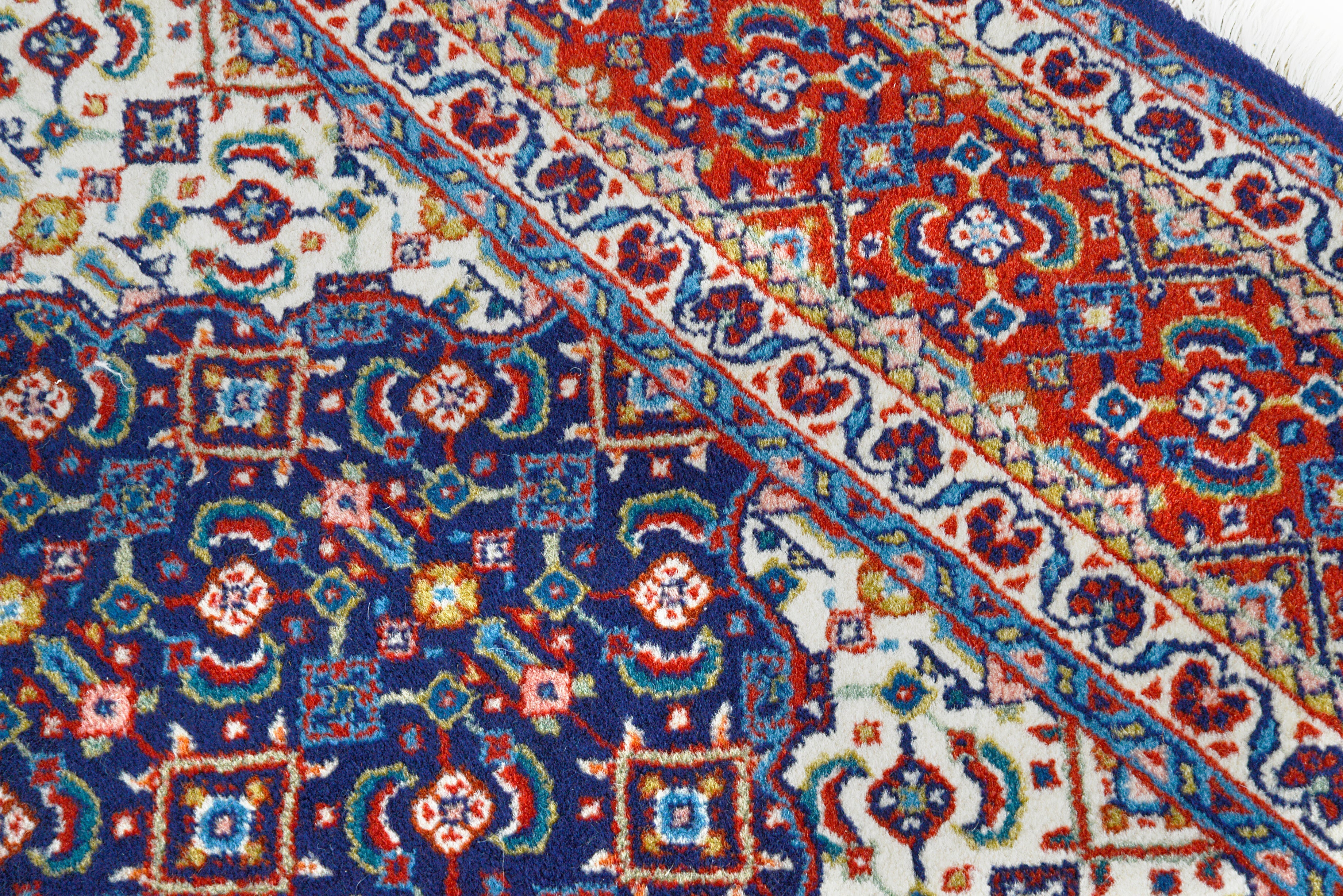 Close-up details of vintage Persian Sarouk rug showing wool texture, motifs, and natural patina
