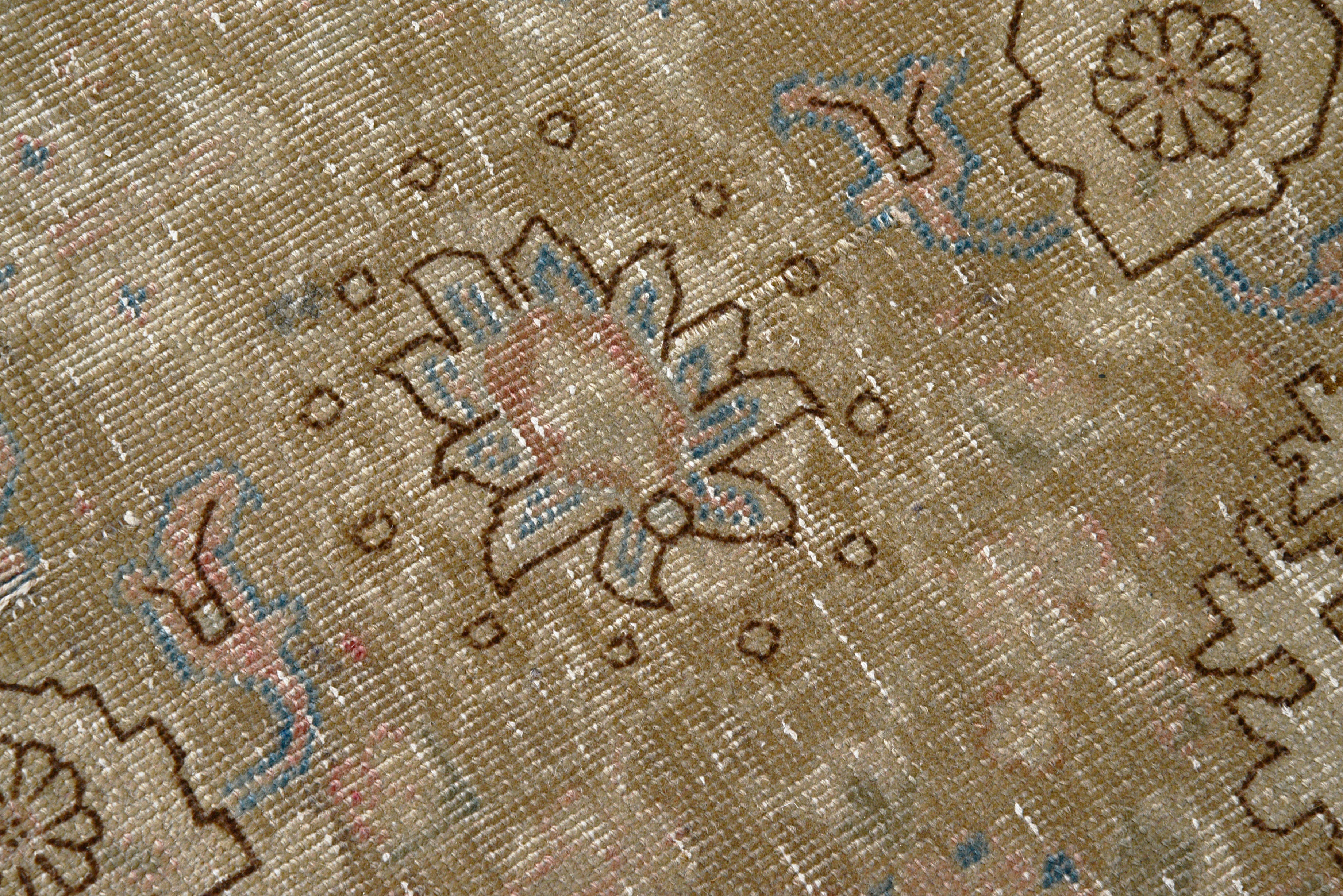 Close-up details of vintage Persian Tabriz carpet showing wool texture, borders, and natural patina
