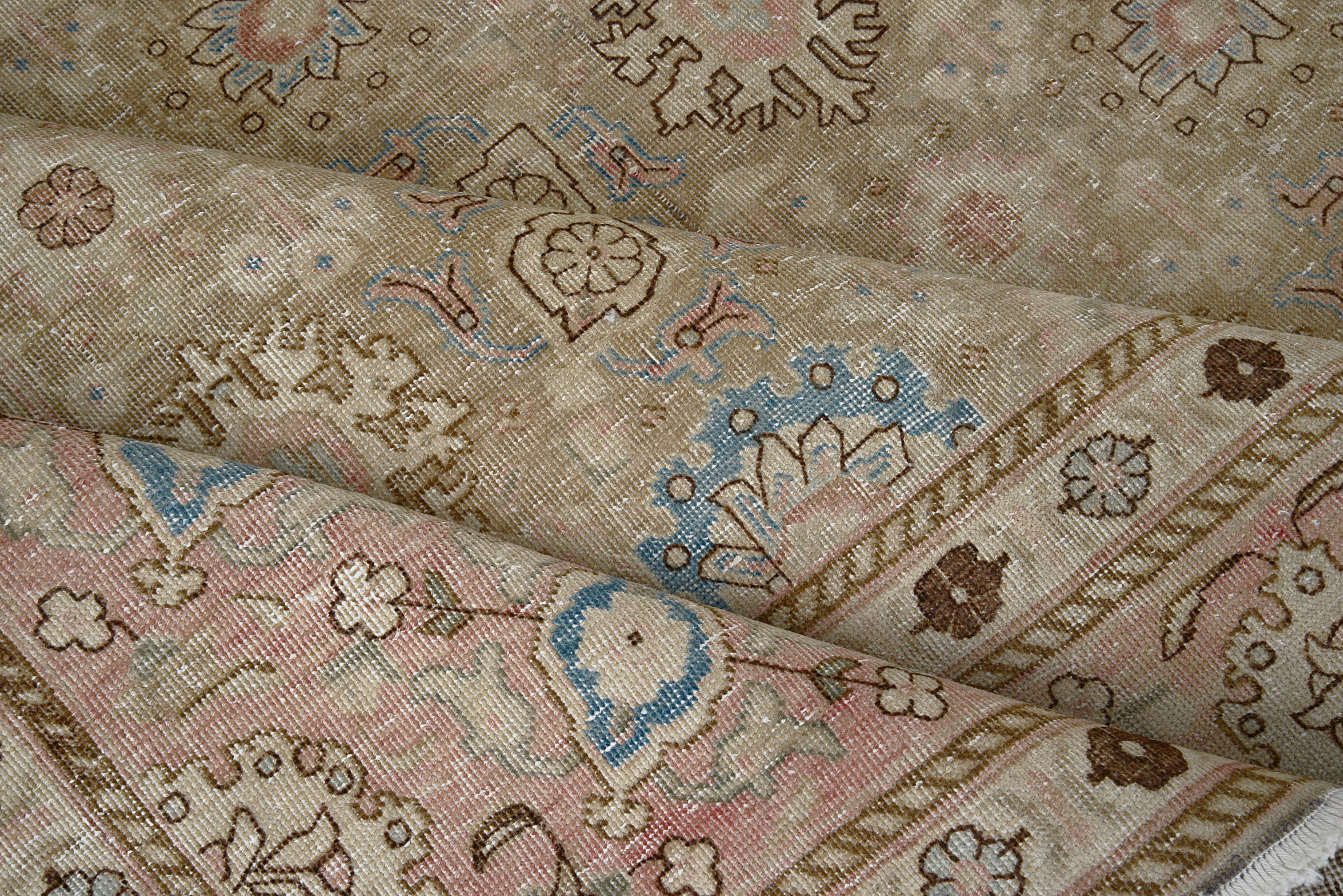 Close-up details of vintage Persian Tabriz carpet showing wool texture, borders, and natural patina
