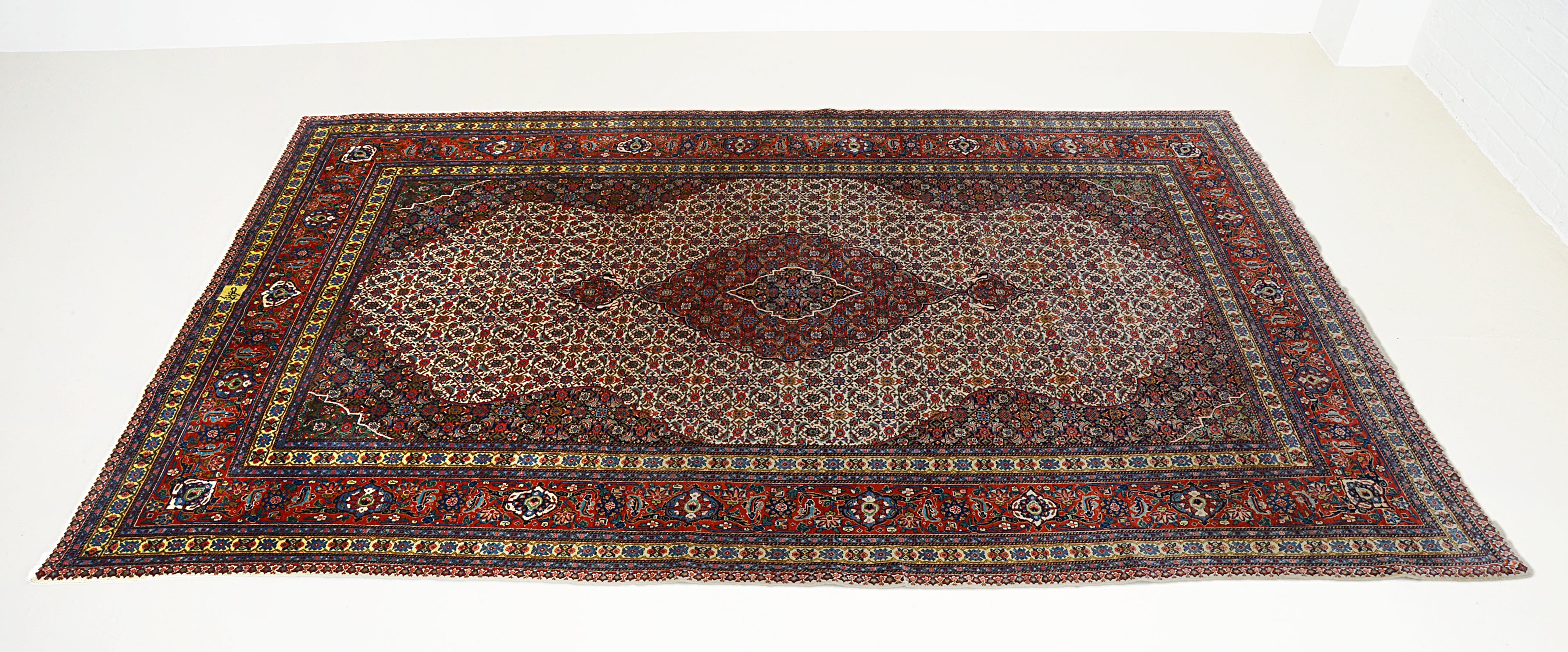 Hand-knotted vintage Tabriz carpet with intricate all-over pattern and rich red tones
