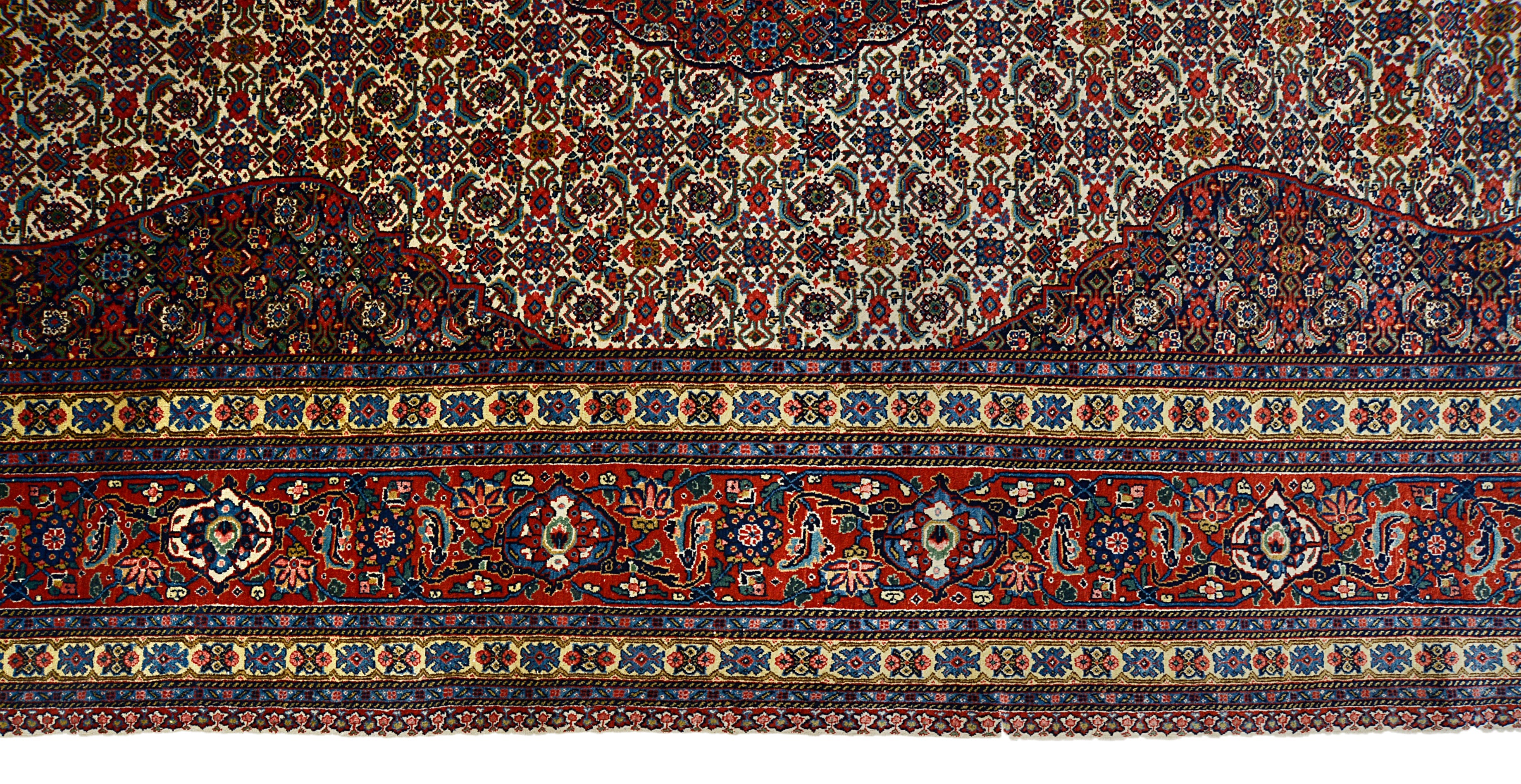 Close-up details of vintage Persian Tabriz carpet showing fine wool texture, motifs, and natural patina
