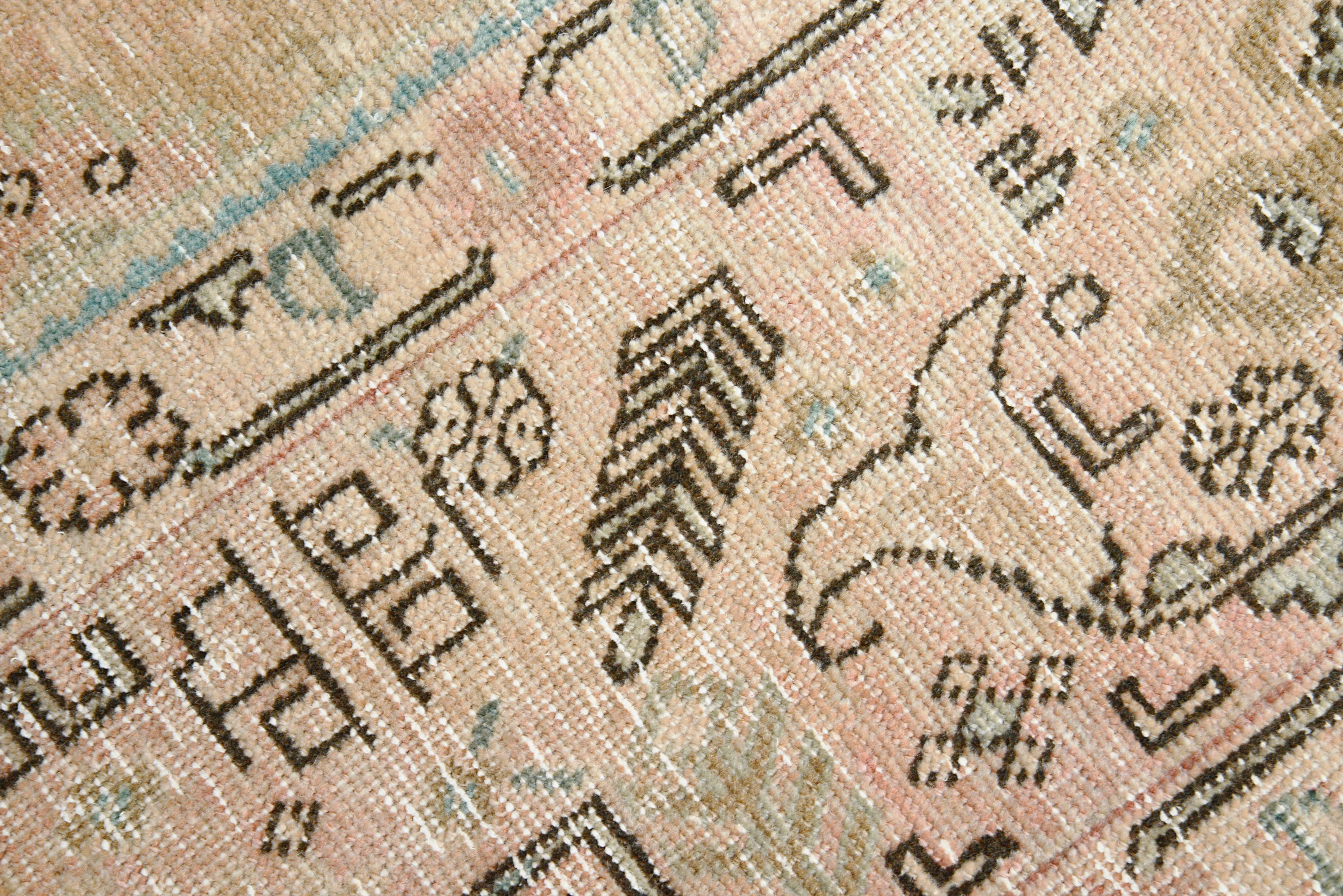 Close-up details of vintage Persian Tabriz carpet showing wool texture, borders, and natural patina
