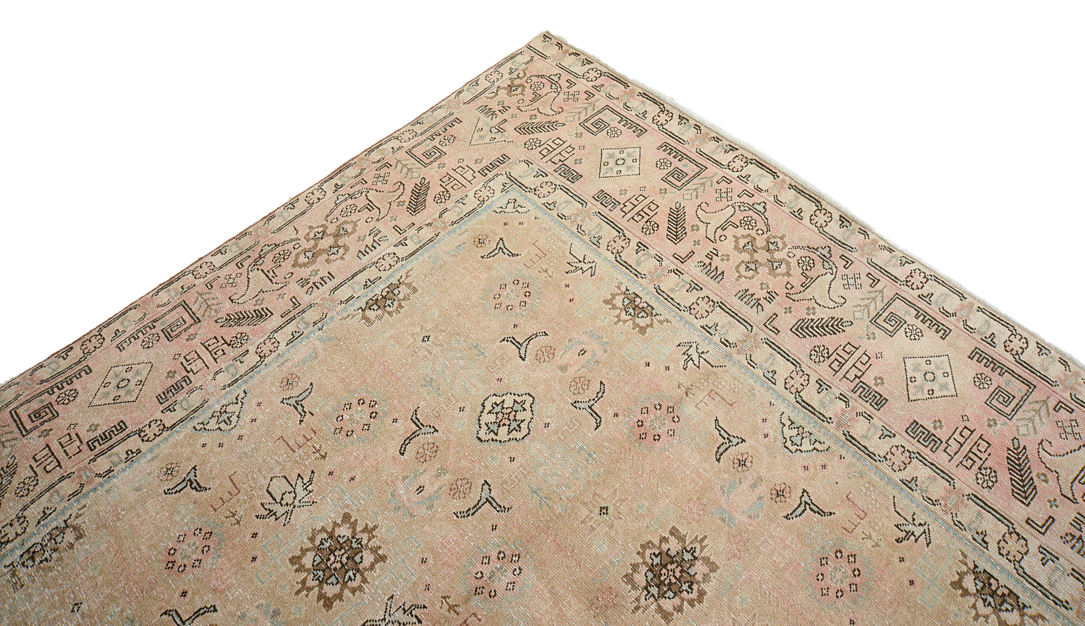 Close-up details of vintage Persian Tabriz carpet showing wool texture, borders, and natural patina
