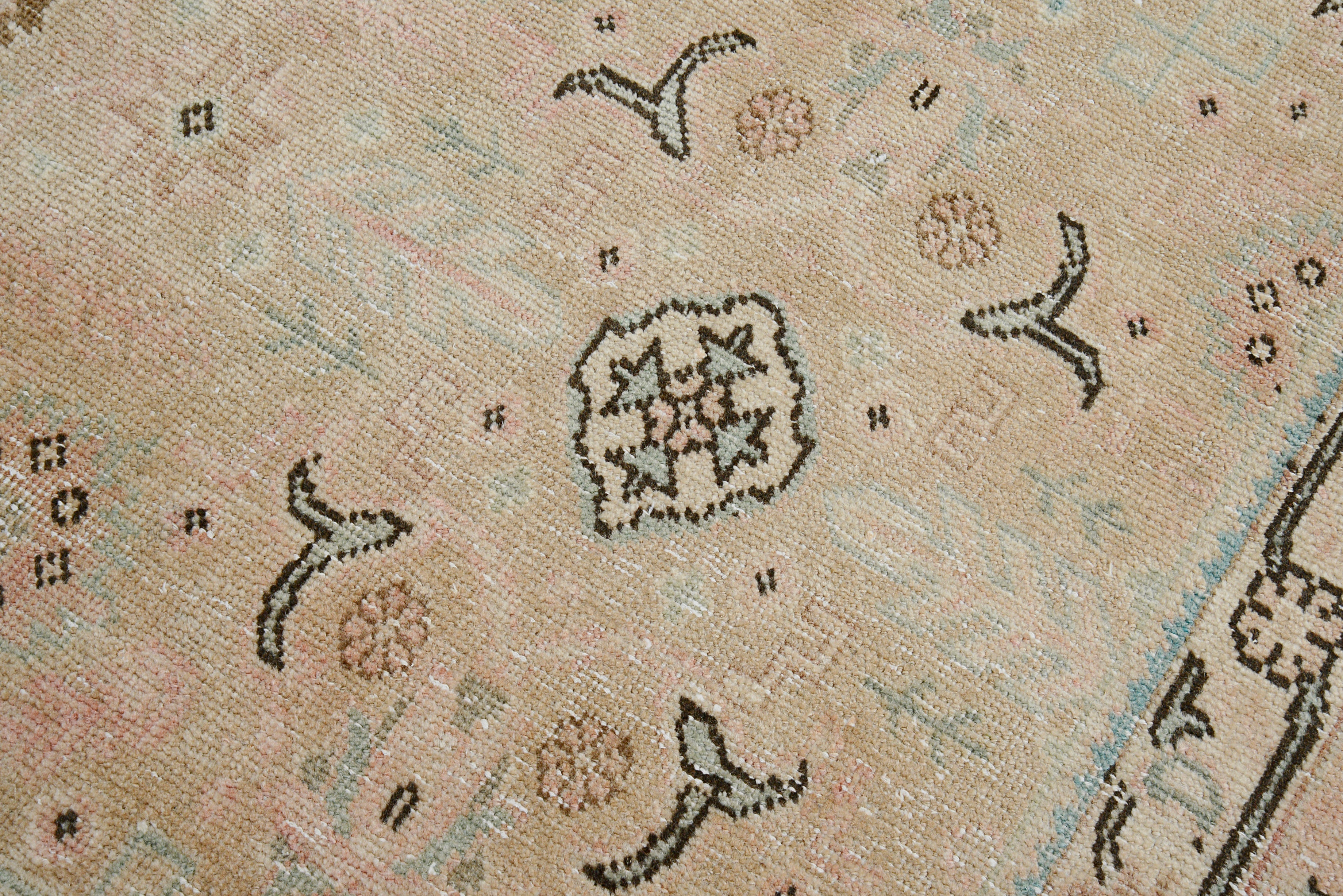 Close-up details of vintage Persian Tabriz carpet showing wool texture, borders, and natural patina
