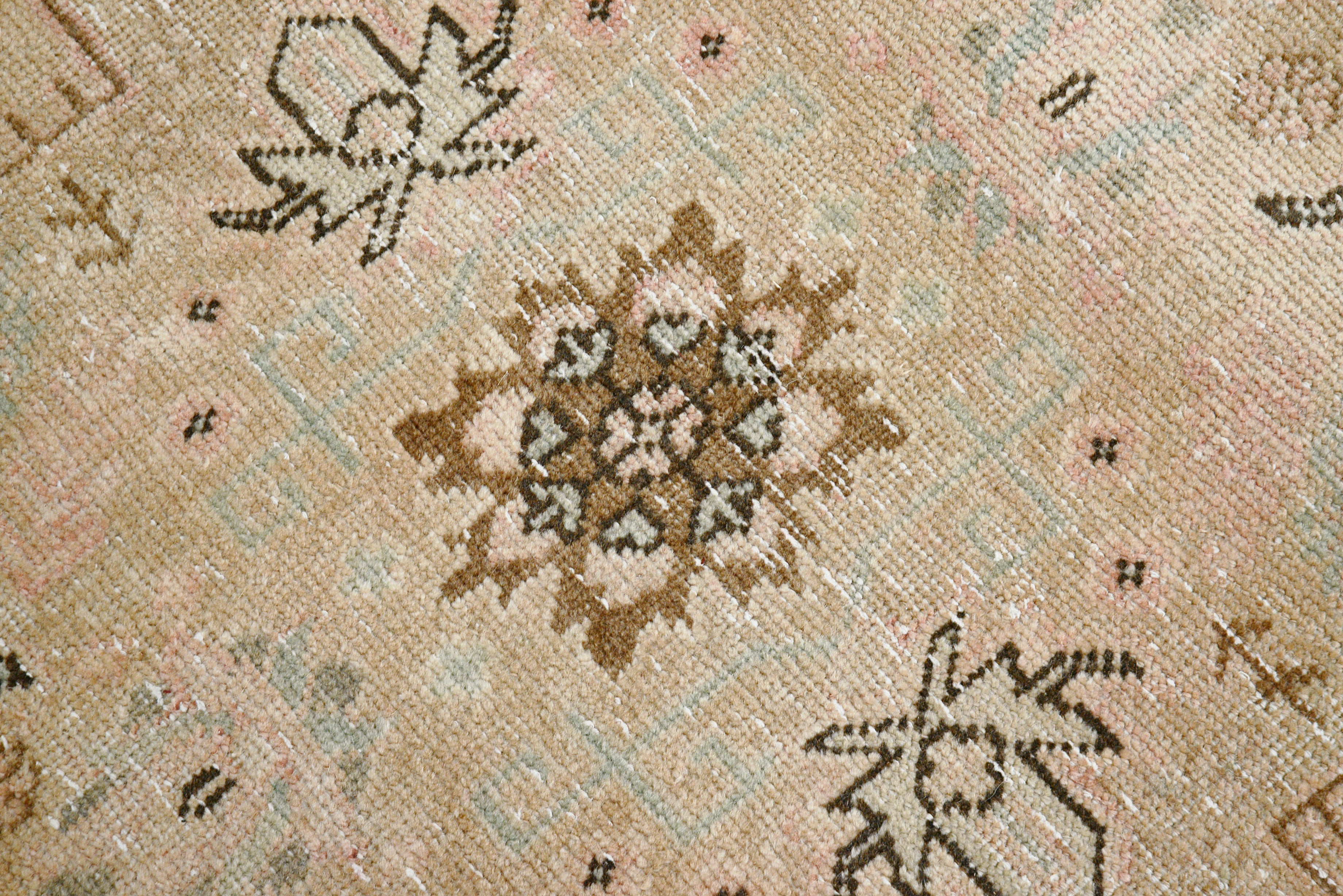 Close-up details of vintage Persian Tabriz carpet showing wool texture, borders, and natural patina
