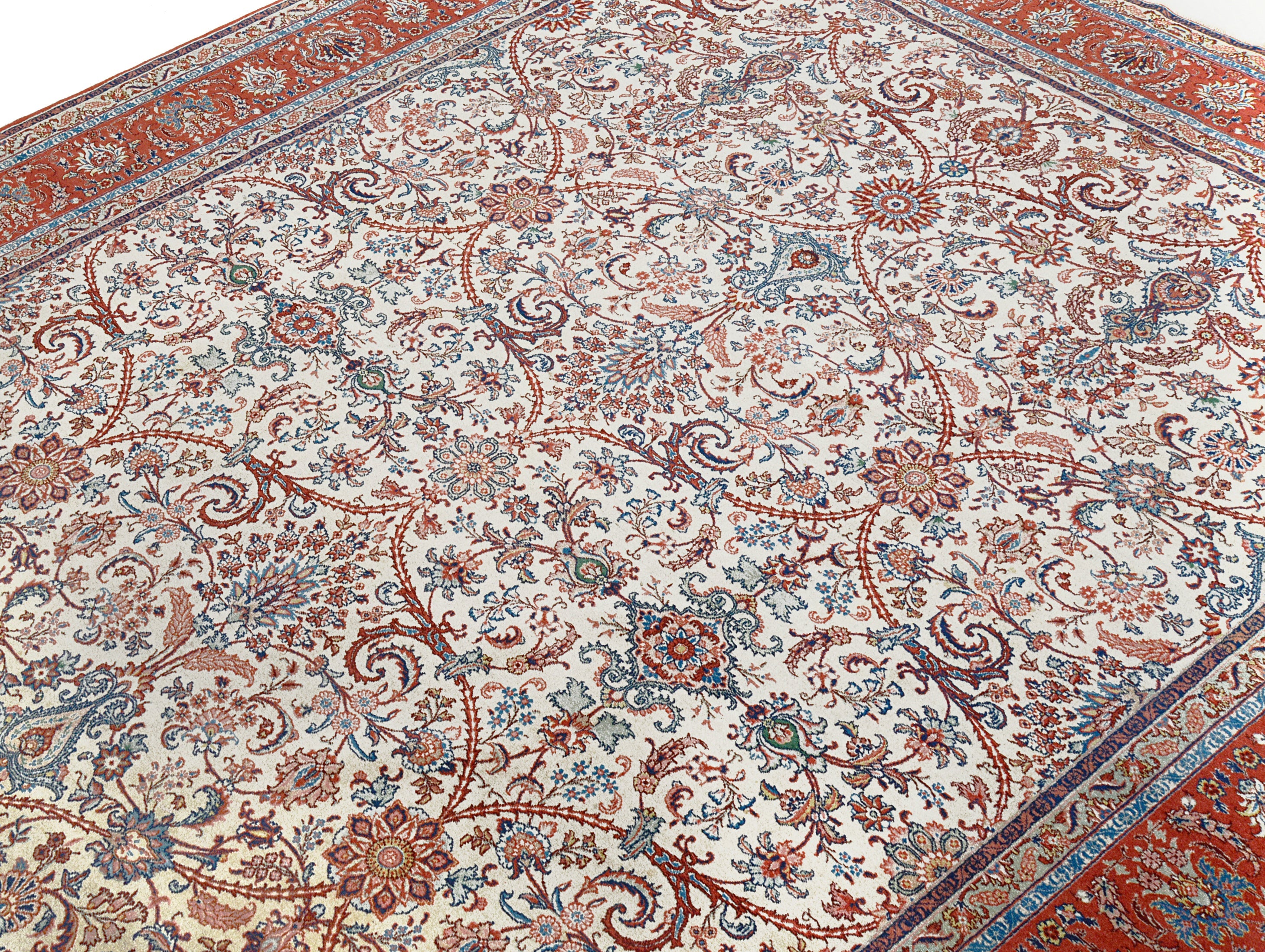 Close-up details of fine antique Persian Tabriz rug showing wool texture, floral motifs, and aged patina