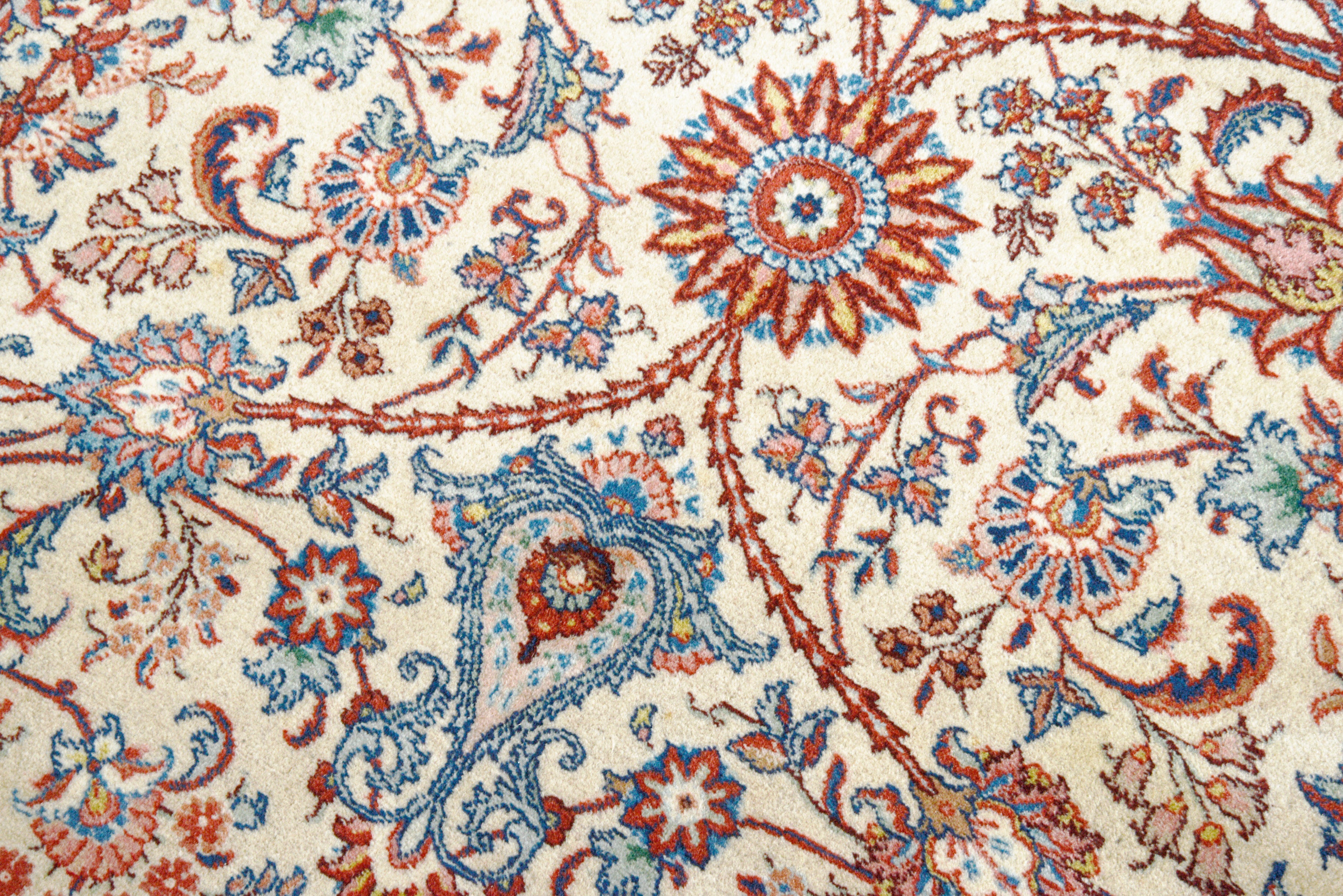 Close-up details of fine antique Persian Tabriz rug showing wool texture, floral motifs, and aged patina