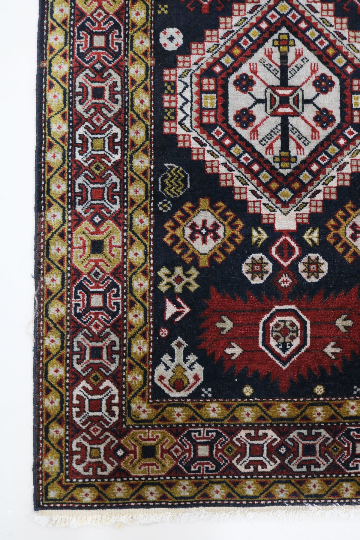 Antique Caucasian Irawan runner with dark field, geometric medallions and rich tribal border
