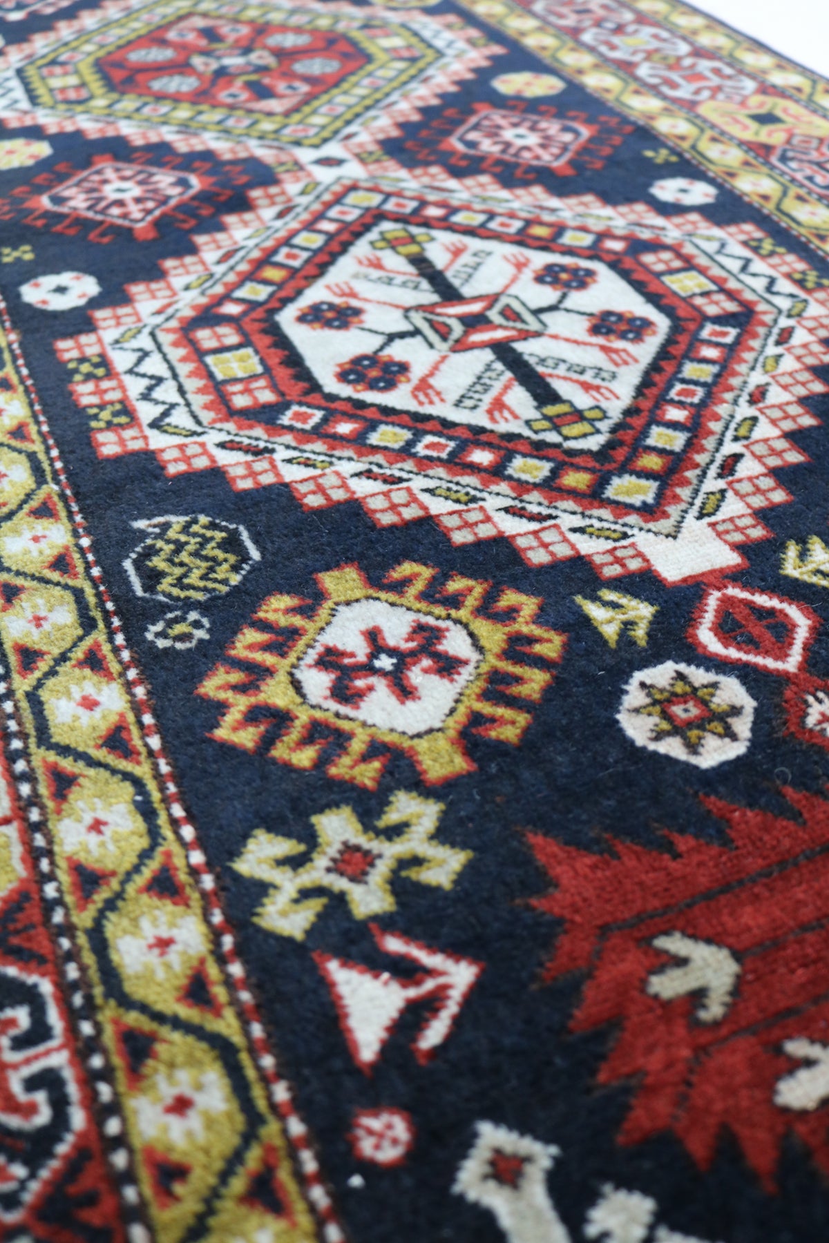 Close-up of Caucasian Irawan runner showing geometric medallions and decorative border