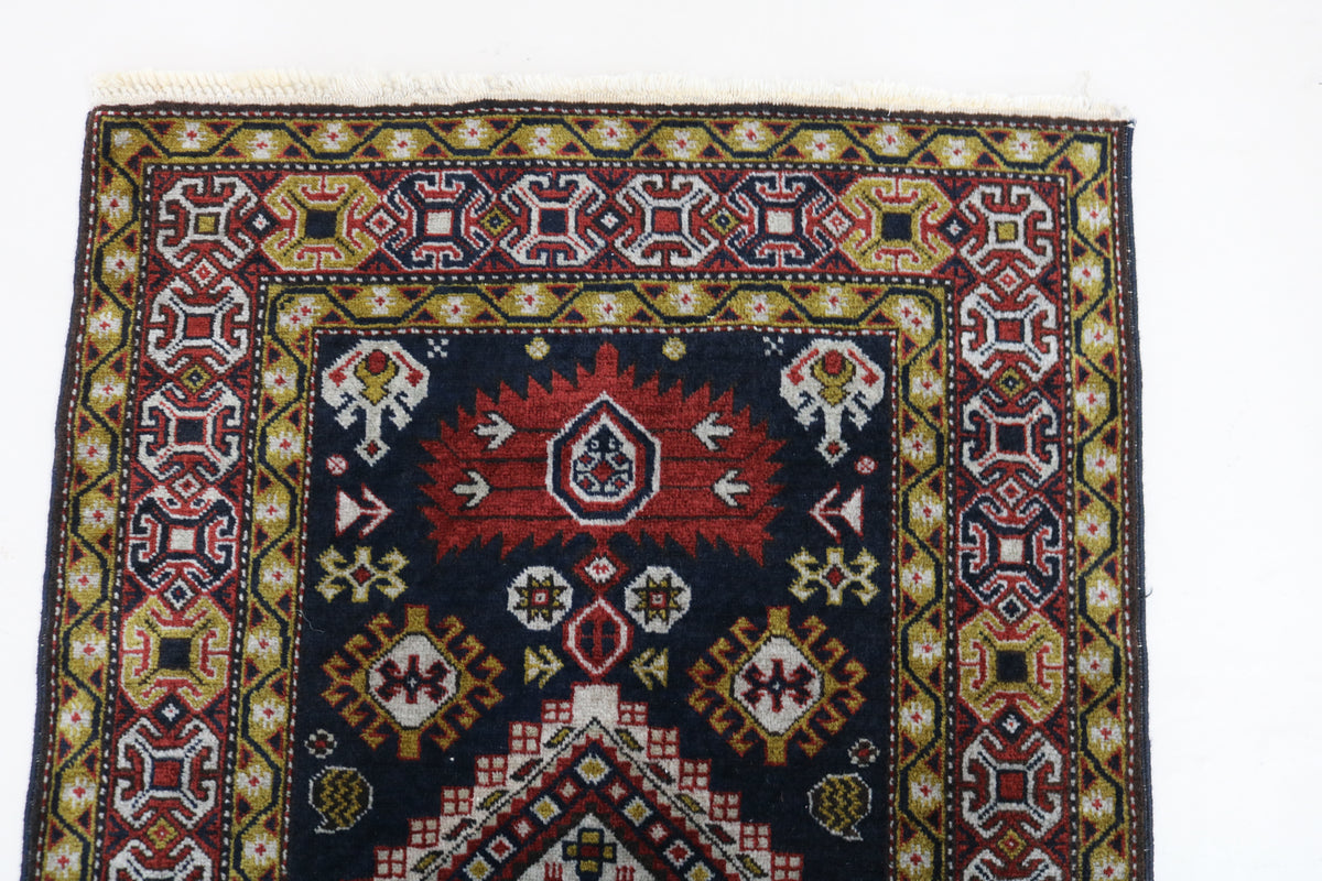 Full Irawan runner showing geometric medallions framed by richly patterned borders