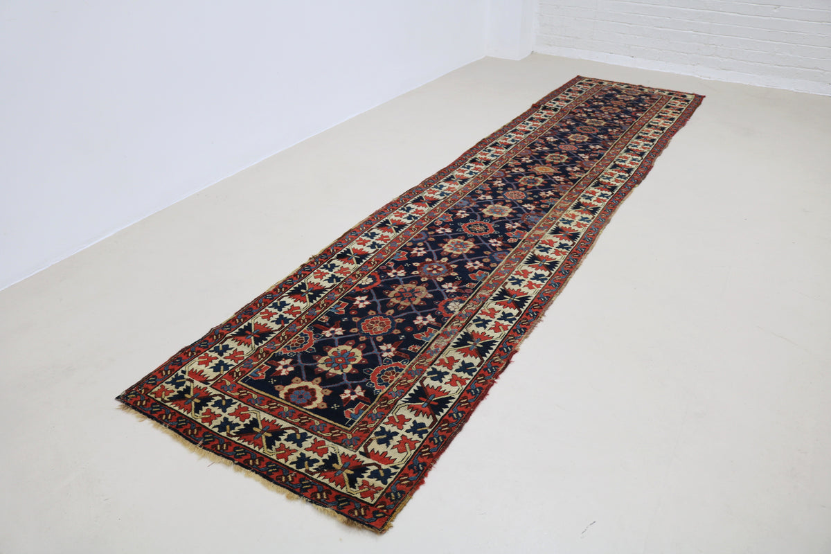 Full view of antique Karabag runner with long narrow format and intricate patterns
