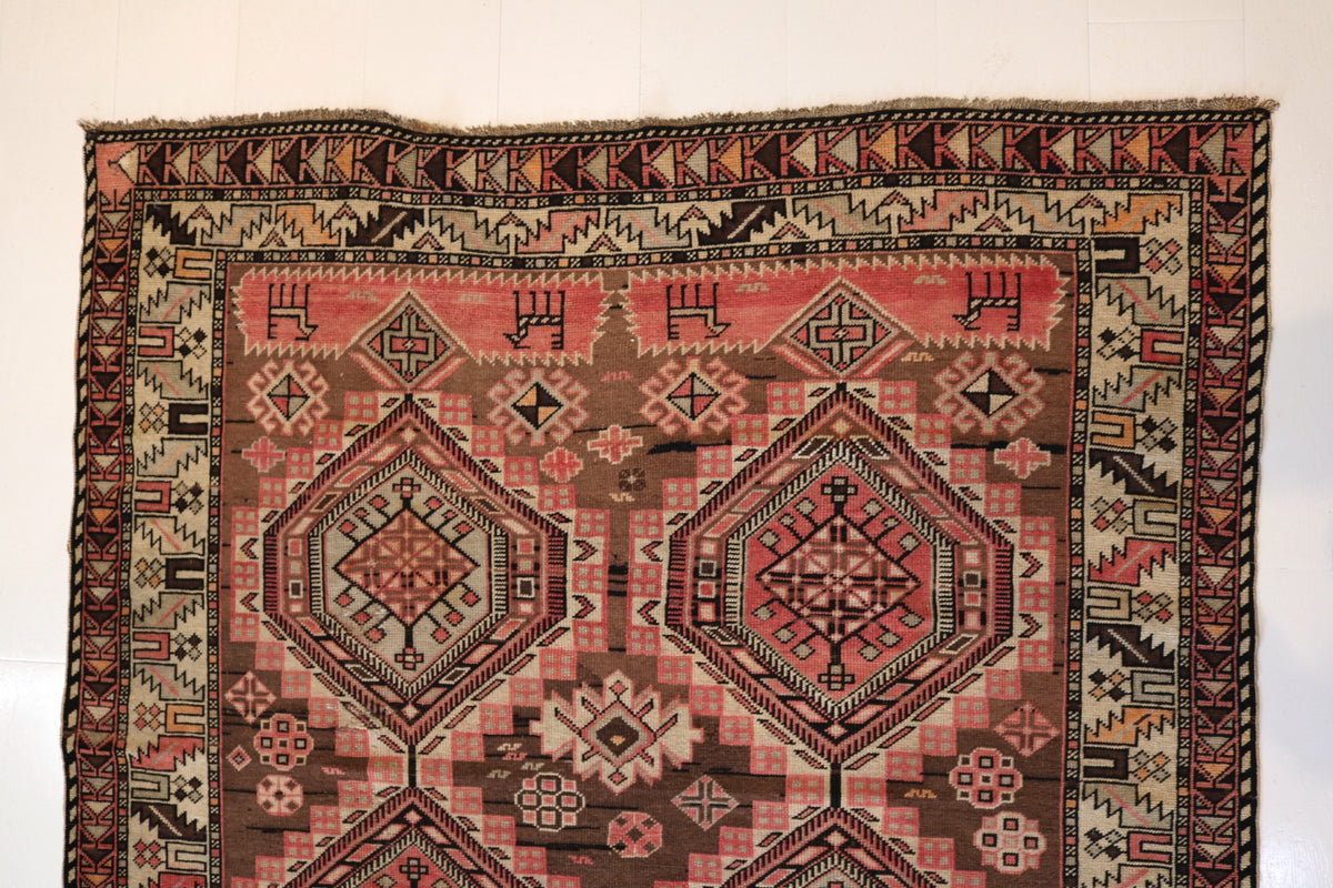 Full rug view highlighting multiple geometric medallions across the field