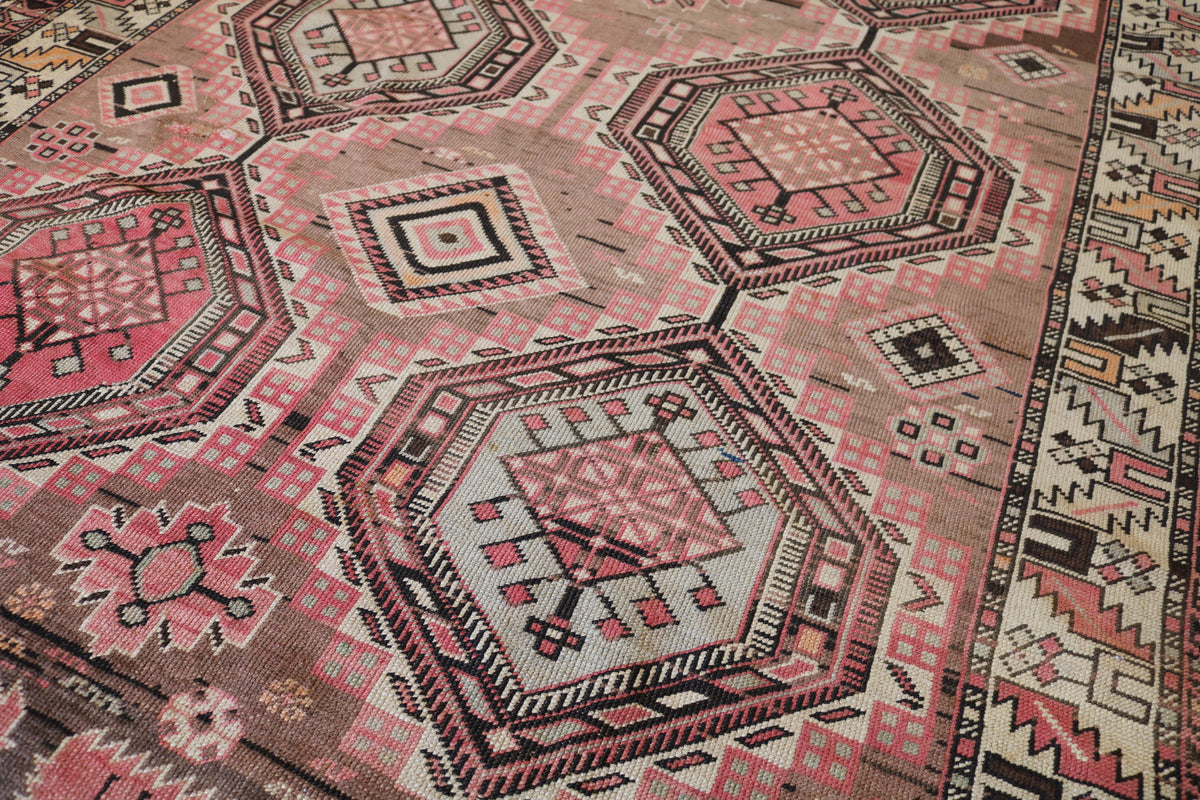 Close-up of central geometric medallion with surrounding floral and tribal motifs