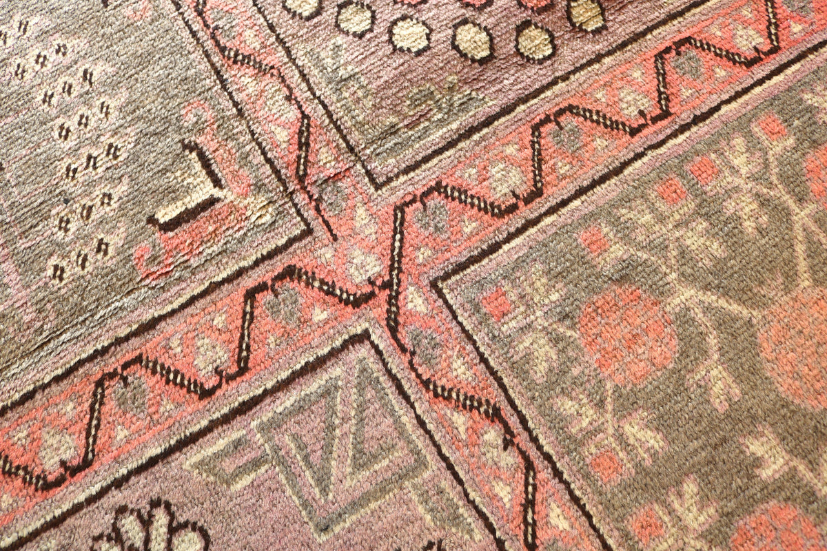 Close-up of geometric field with floral motifs in soft earthy colours