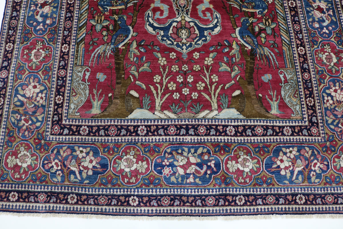 Full Isfahan rug featuring a richly decorated red field and detailed surrounding borders